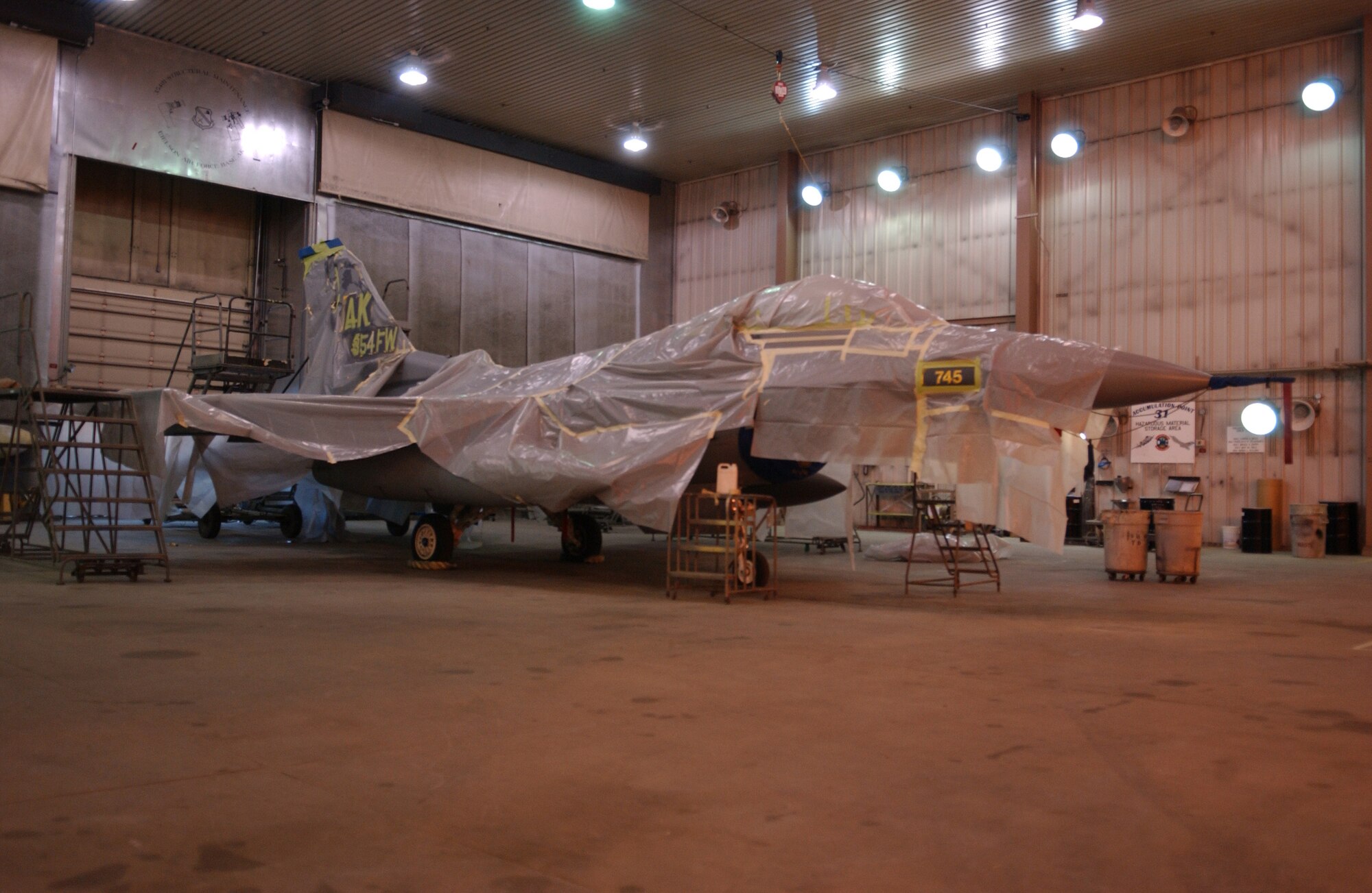 EIELSON AIR FORCE BASE, Alaska -- 'ICEMAN One', the 354th Wing Commanders' F-16 Fighting Falcon, receives a new tail design and a paint touch up here April 11.  The paint job will help prevent future corrosion.  (U.S. Air Force Photo by Airman 1st Class Jonathan Snyder)