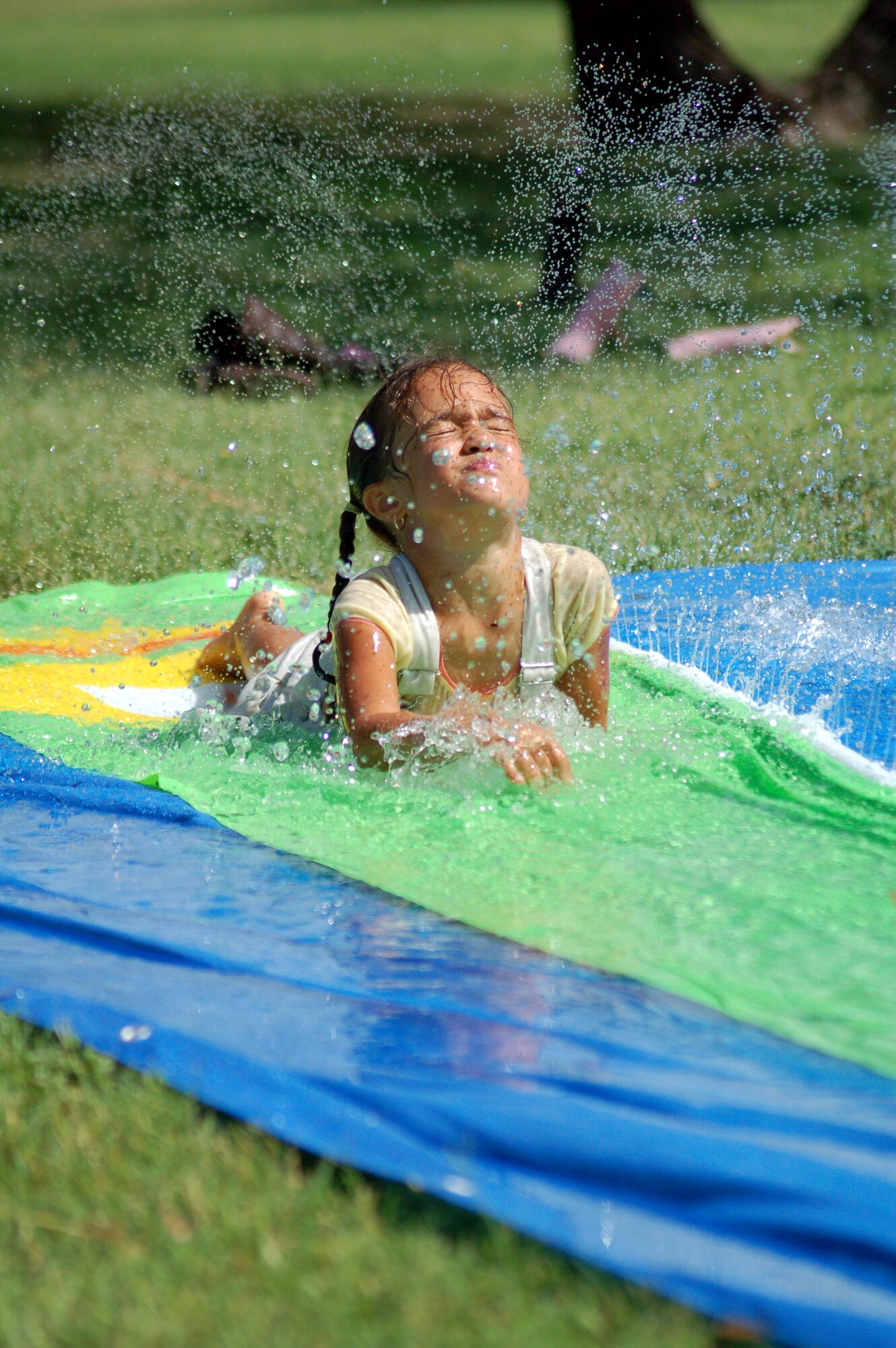 Mikayla Davis, 5, daughter of Seanna and Senior Airman Nick Davis, 47th Flying Training Wing command post, hits the water on a slip and slide at the 47th Services Division’s Wild Western Day July 29, 2006. This photo by Staff Sgt. Austin May, of the 47th Flying Training Wing public affairs office, was judged Best Stand-alone Photo in the Air Force in the 2006 Air Force Media Contest.