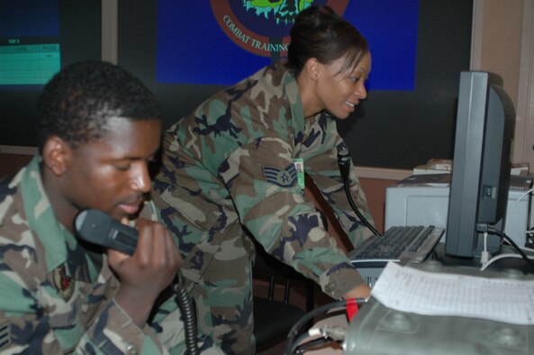 EIELSON AIR FORCE BASE, Alaska--Staff Sgt. Hieya Franklin and Senior Airman Earnest Hooks, 61st Fighter Squadron aviation resource managers, pass along vital aircraft status information from the operations desk during RED FLAG-Alaska 07-1 here April 11. Red Flag-Alaska is a Pacific Air Forces-directed field training exercise for U.S. forces flown under simulated air combat conditions. It is conducted on the Pacific Alaskan Range Complex with air operations flown out of Eielson and Elmendorf Air Force Bases. (U.S. Air Force photo by Tech. Sgt. William Farrow).