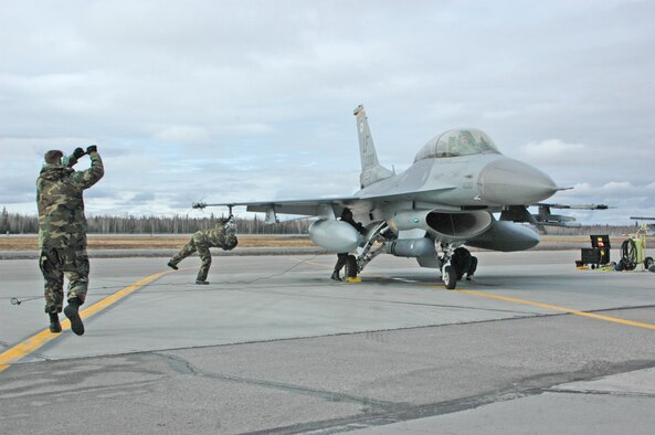 EIELSON AIR FORCE BASE, Alaska--Airmen from the 61st Fighter Squadron catch a Luke F-16 on the flightline at Eielson Air Force Base, Alaska during Red Flag-Alaska 07-1 here April 11. Red Flag-Alaska is a Pacific Air Forces-directed field training exercise for U.S. forces flown under simulated air combat conditions. It is conducted on the Pacific Alaskan Range Complex with air operations flown out of Eielson and Elmendorf Air Force Bases.(U.S. Air Force photo by Tech. Sgt. William Farrow).