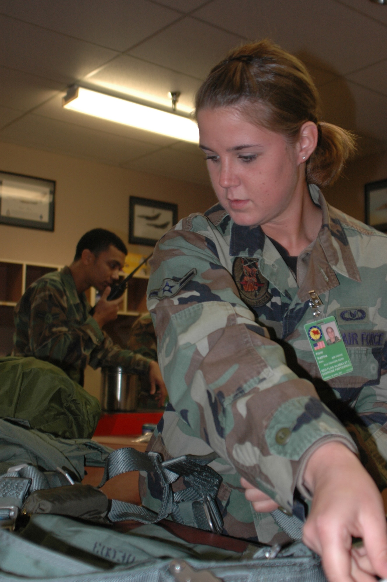 EIELSON AIR FORCE BASE, Alaska--Airman Katrina Kane, 61st Fighter Squadron life support specialist, breaks down aircrew gear during Red Flag-Alaska 07-1 here April 11. Red Flag-Alaska is a Pacific Air Forces-directed field training exercise for U.S. forces flown under simulated air combat conditions. It is conducted on the Pacific Alaskan Range Complex with air operations flown out of Eielson and Elmendorf Air Force Bases. (U.S. Air Force photo by Tech. Sgt. William Farrow).