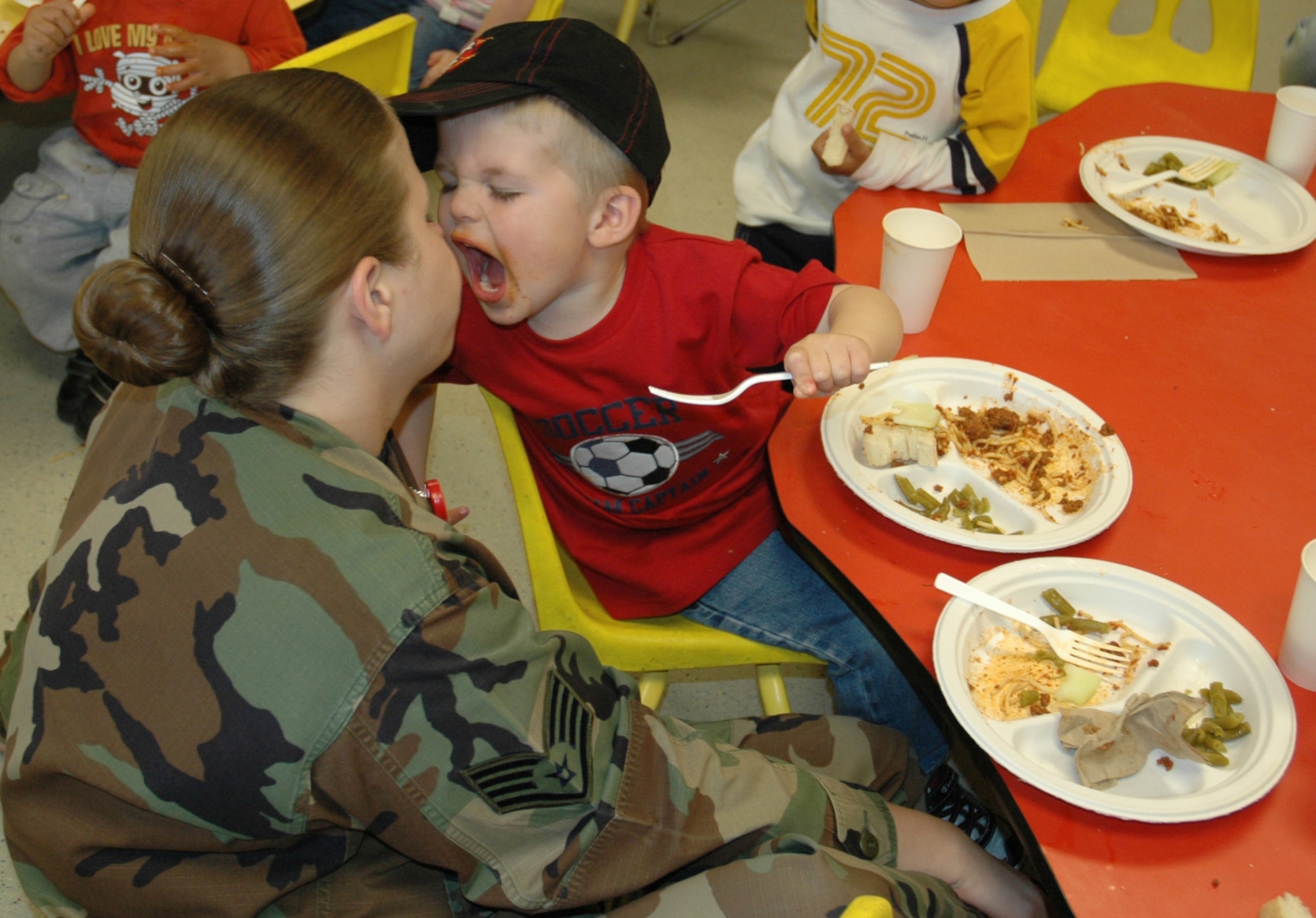 Staff Sgt. Dallas Swalla , 22nd  Medical Operations Squadron joins her son Conner, 3, at the Child Development Center April 11 for the Annual Month of the Military Child luncheon.  (Air Force photo by Tech. Sgt. Genevieve Morris 22nd ARW Public Affairs)