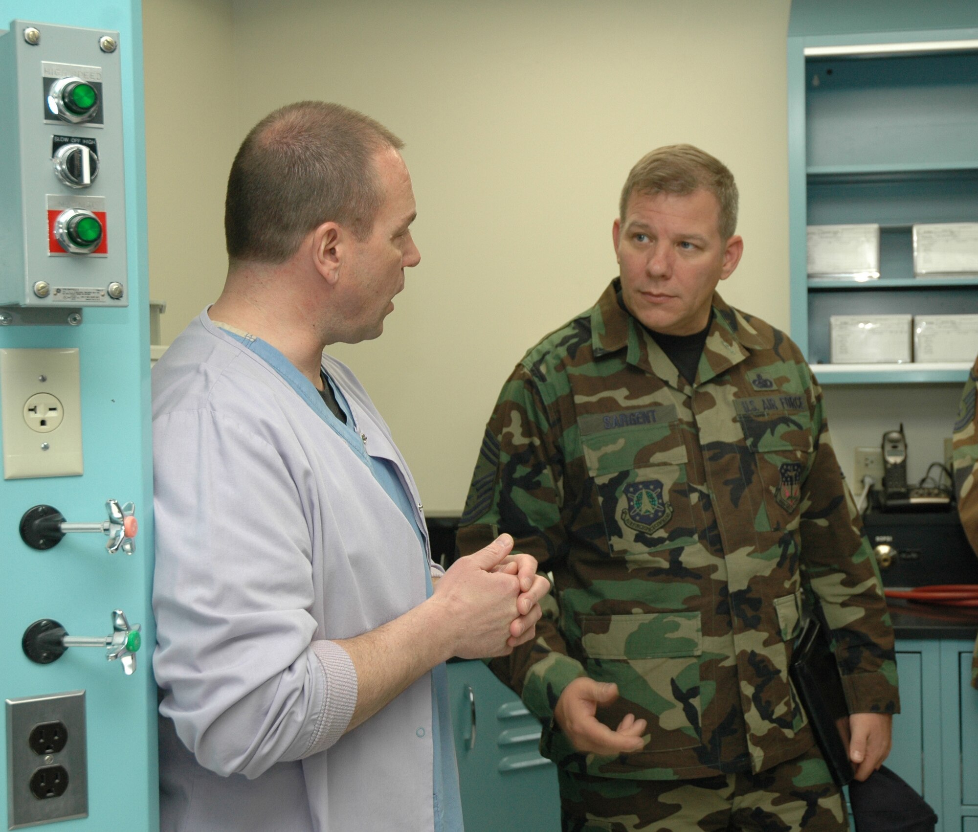 Chief Master Sgt. Steve Sargent, 341st Space Wing command chief, discusses lab practices with Tech. Sgt. Richard Petrucci, dental lab technician, during a tour of the clinic April 9.