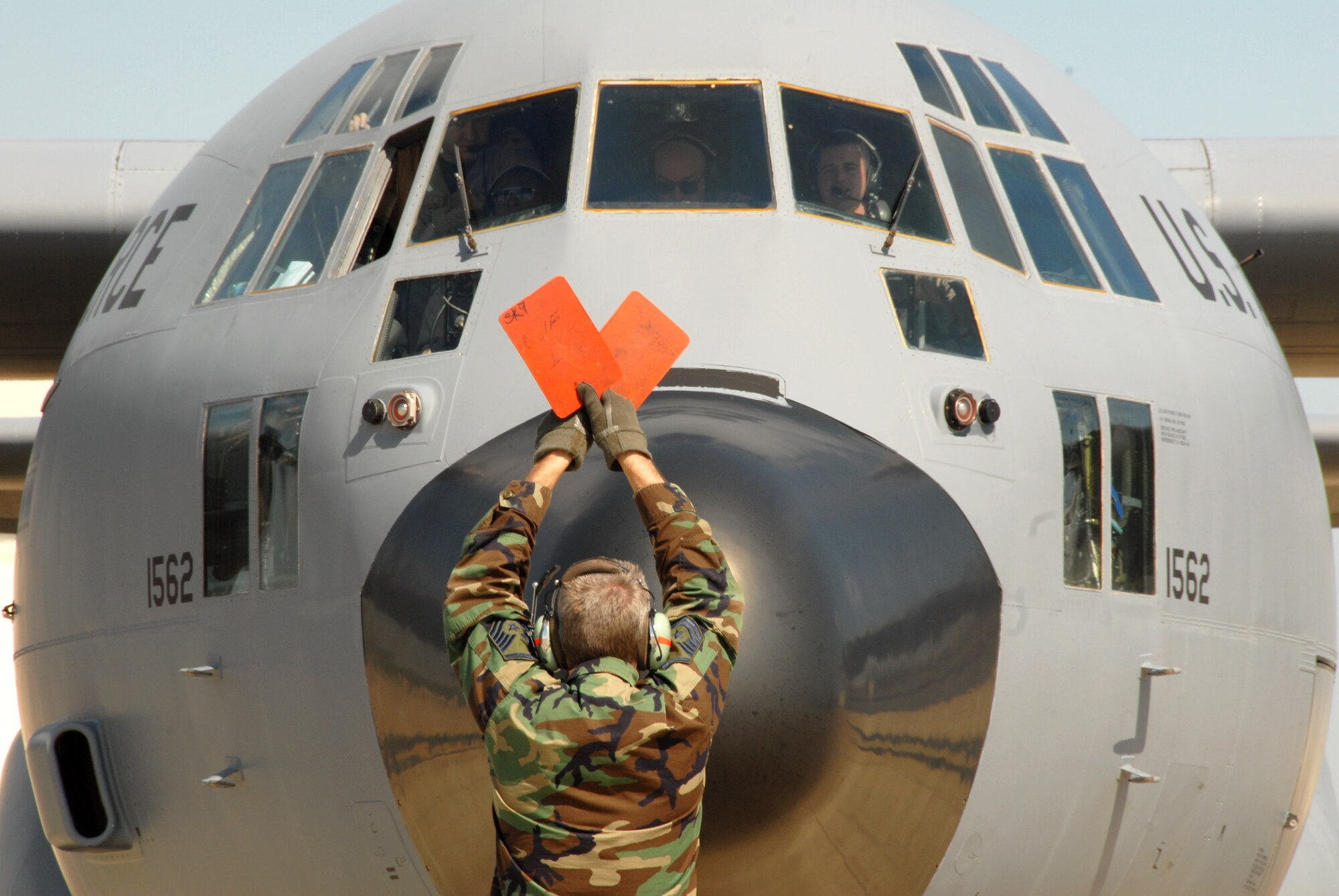 Master Sgt. James Holder directs a C-130 Hercules April 6 at Charlotte Douglas International Airport in North Carolina. The plane and crew are assigned to the 145th Airlift Wing of the North Carolina Air National Guard, and is returning from a tour of duty in Afganistan. (U.S. Air Force photo/Tech. Sgt. Brian E. Christiansen)

