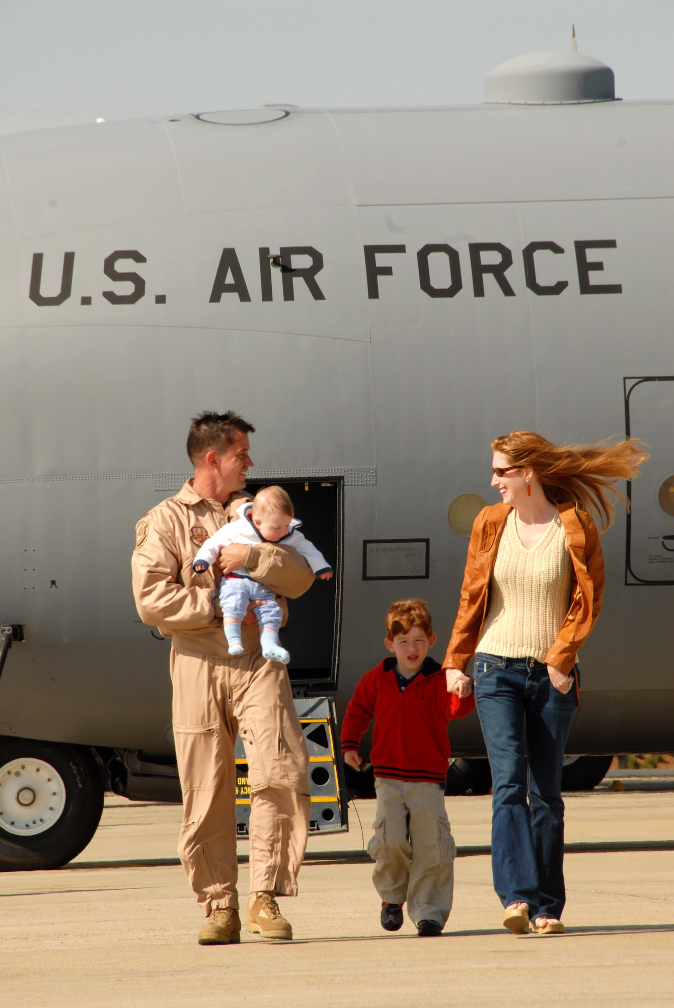 Maj. Kevin Mountcastle talks with his family after giving them a tour of a C-130 Hercules after arriving back home April 6 from supporting Operation Enduring Freedom to Charlotte, N.C. Major Mountcastle is a C-130 Hercules pilot assigned to the 145th Airlift Wing for the North Carolina Air National Guard, and is returning from a tour of duty in Afganistan. (U.S. Air Force photo/Tech. Sgt. Brian E. Christiansen)

