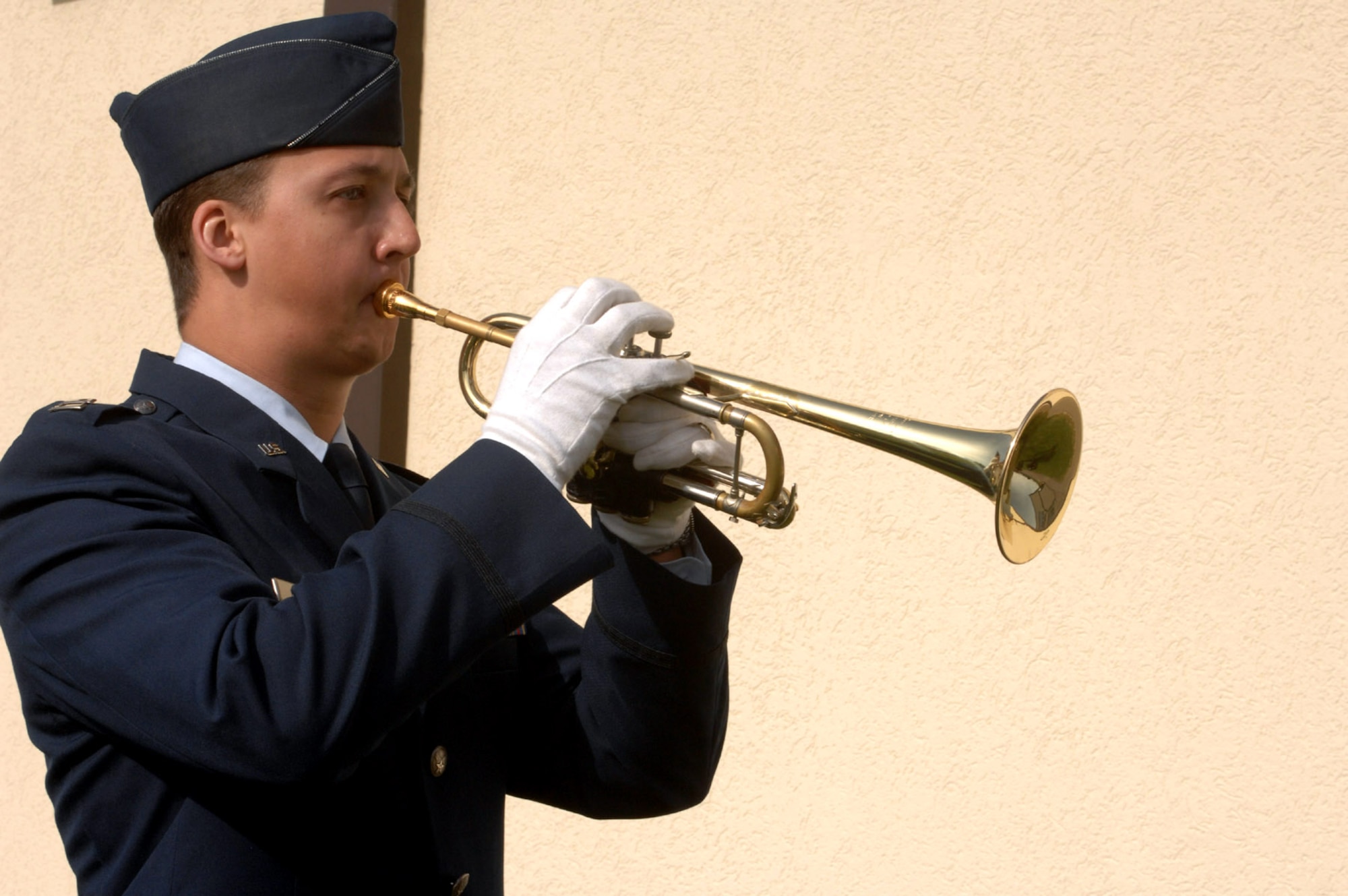 Capt. Mike McCarthy plays "Taps" during a ceremony memorializing the life of Maj. Troy Gilbert at Bitburg High School April 5 near Spangdhalem Air Base, Germany. Major Gilbert, a BHS graduate, lost his life while serving in support of Operation Iraqi Freedom Nov. 26 while he was on a mission providing combat support to an Army helicopter crew that had crashed as well as the ground forces trying to reach the crash site in the Anbar Province, 20 miles northwest of Baghdad. Captain McCarthy is assigned to the 23rd Fighter Squadron, Major Gilbert's former unit. (U.S. Air Force photo/Airman 1st Class Emily Moore)