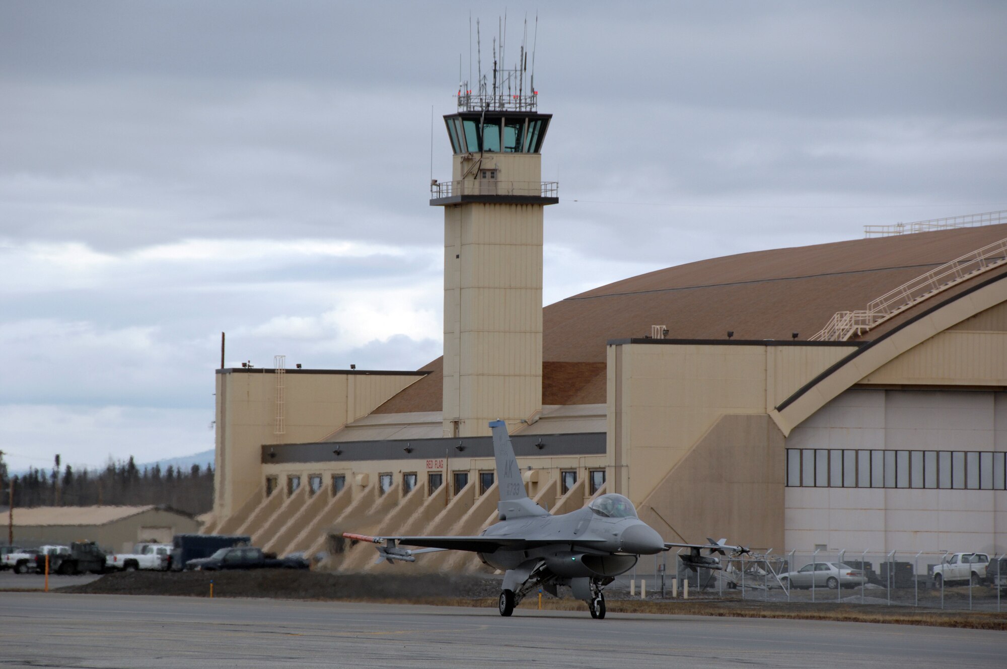 EIELSON AIR FORCE BASE, Alaska -- An F-16 Fighting Falcon from the 18th Fighter Squadron, Eielson Air Force Base, Alaska taxis past the Red Flag hangar prior to a mission during Red Flag-Alaska 07-1 here on April 11. Red Flag-Alaska is a Pacific Air Forces-directed field training exercise for U.S. forces flown under simulated air combat conditions. It is conducted on the Pacific Alaskan Range Complex with air operations flown out of Eielson and Elmendorf Air Force Bases. 
(U.S. Air Force Photo by Staff Sgt Joshua Strang) 