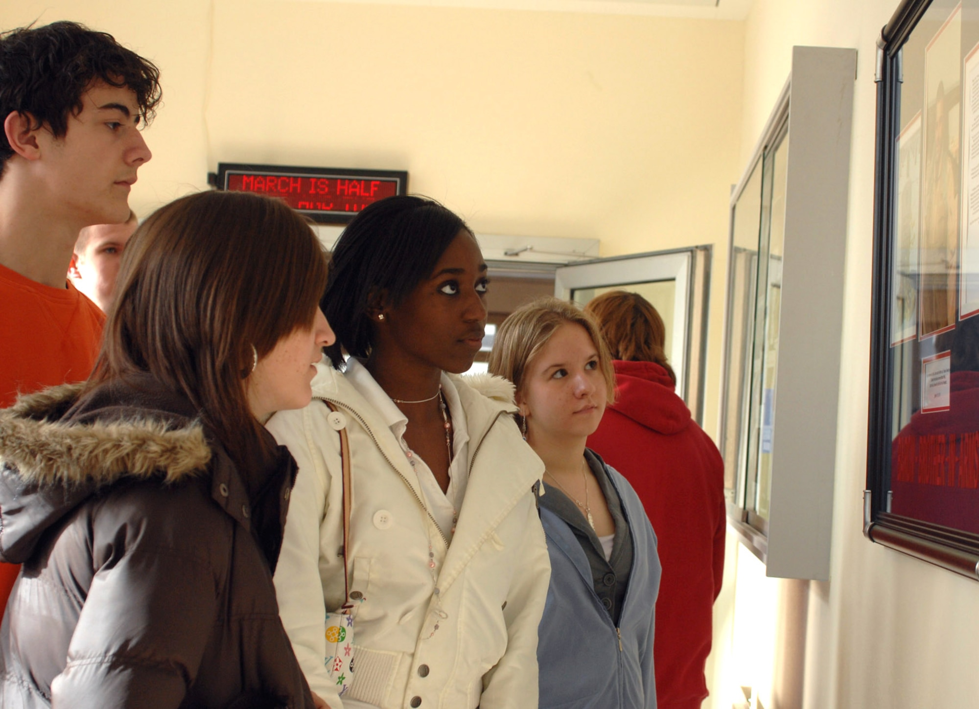 Bitburg High School students examine a commemorative plaque hung in the memory of Maj. Troy Gilbert April 5 at the school near Spangdhalem Air Base, Germany. Major Gilbert, a BHS graduate, lost his life while serving in support of Operation Iraqi Freedom Nov. 27, 2006. (U.S. Air Force photo/Airman 1st Class Emily Moore)