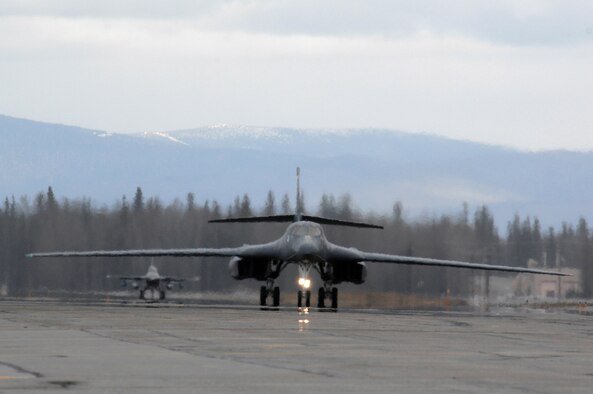 EIELSON AIR FORCE BASE, Alaska -- A B-1B Lancer, 28th Bomb Wing, Ellsworth Air Force Base, South Dakota and an F-16 Fighting Falcon, 18th Fighter Squadron, Eielson Air Force Base, Alaska taxi on the flightline during Red Flag-Alaska 07-1 here on April 11. Red Flag-Alaska is a Pacific Air Forces-directed field training exercise for U.S. forces flown under simulated air combat conditions. It is conducted on the Pacific Alaskan Range Complex with air operations flown out of Eielson and Elmendorf Air Force Bases. 
(U.S. Air Force Photo by Staff Sgt Joshua Strang) 