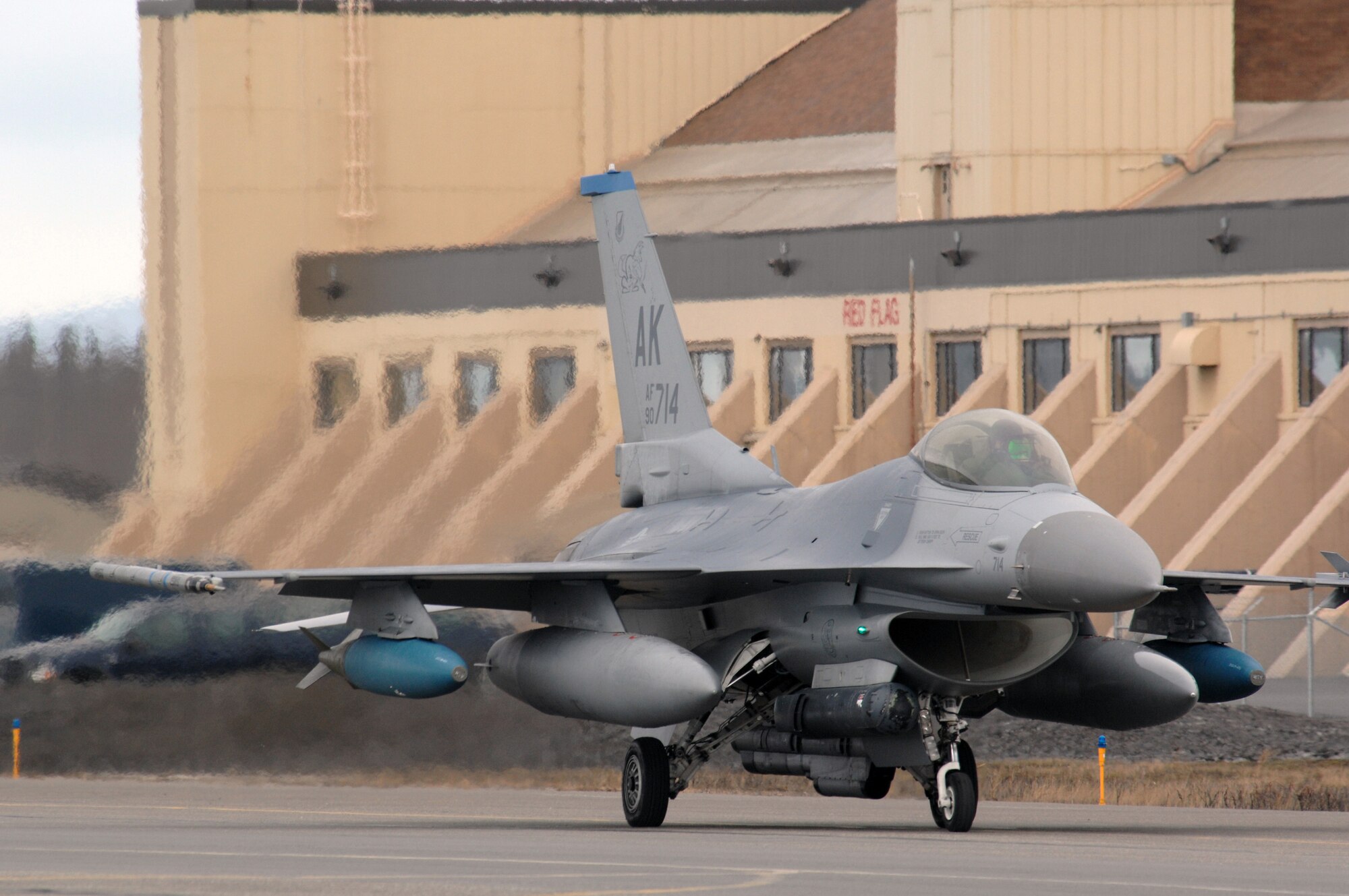 EIELSON AIR FORCE BASE, Alaska -- An F-16 Fighting Falcon from the 18th Fighter Squadron, Eielson Air Force Base, Alaska taxis past the Red Flag hangar prior to a mission during Red Flag-Alaska 07-1 here on April 11. Red Flag-Alaska is a Pacific Air Forces-directed field training exercise for U.S. forces flown under simulated air combat conditions. It is conducted on the Pacific Alaskan Range Complex with air operations flown out of Eielson and Elmendorf Air Force Bases. 
(U.S. Air Force Photo by Staff Sgt Joshua Strang) 