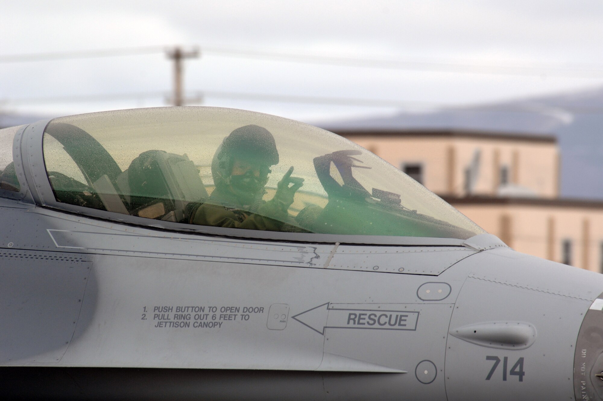EIELSON AIR FORCE BASE, Alaska -- An F-16 Fighting Falcon pilot from the 18th Fighter Squadron, Eielson Air Force Base, Alaska signals to the camera prior to a mission during Red Flag-Alaska 07-1 here on April 11. Red Flag-Alaska is a Pacific Air Forces-directed field training exercise for U.S. forces flown under simulated air combat conditions. It is conducted on the Pacific Alaskan Range Complex with air operations flown out of Eielson and Elmendorf Air Force Bases. 
(U.S. Air Force Photo by Staff Sgt Joshua Strang) 