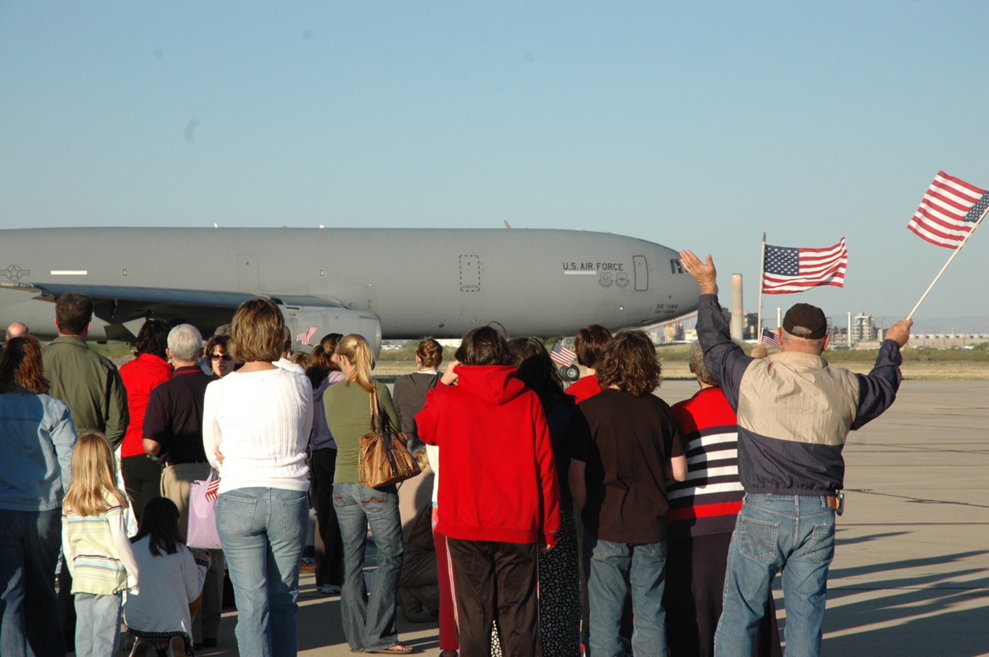 Friends, family members and colleagues watch and wave as a KC-10 aircraft makes its way to the runway here for takeoff. The KC-10 left D-M April 7 to provide air-refueling support to 12 A-10 pilots, who departed for Afghanistan in support of Operation Enduring Freedom. (U.S. Air Force photo/Airman 1st Class Melissa Taeu)
