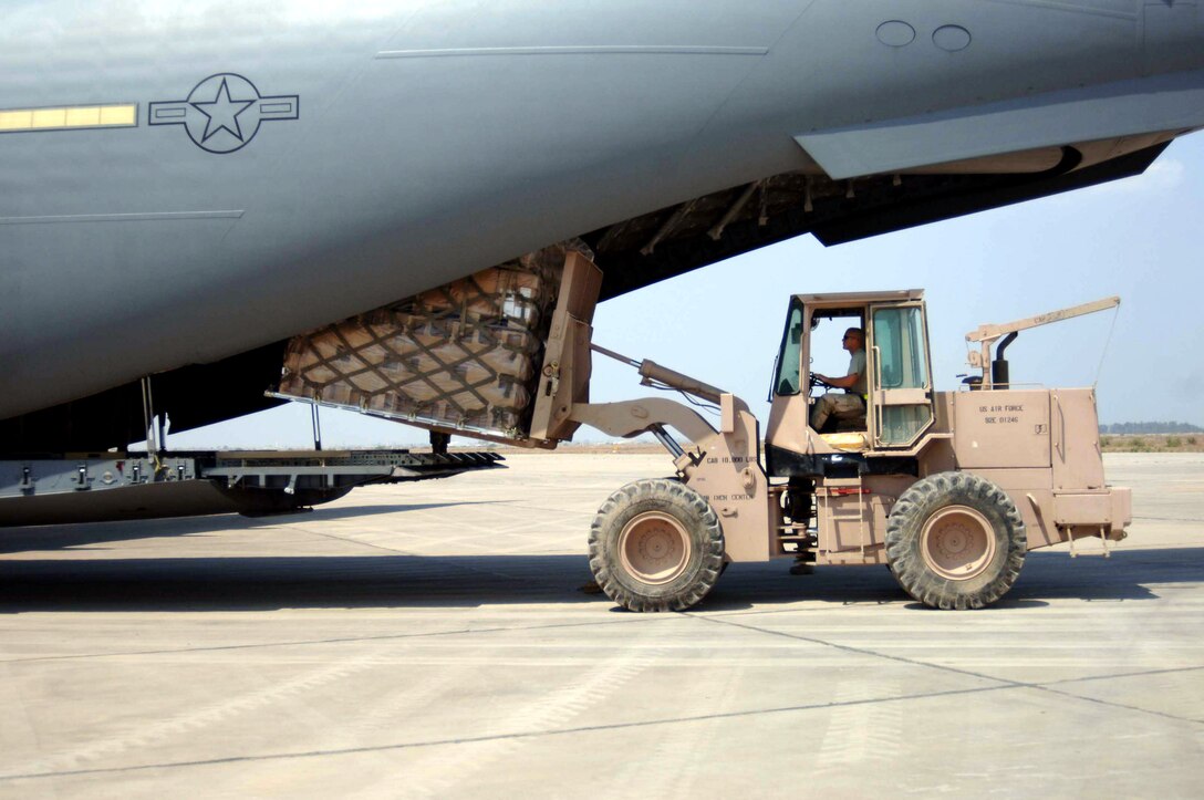 Staff Sgt. Frank Douglass unloads a pallet of cargo from a C-17 Globemaster III April 12 at Baghdad International Airport, Iraq.  Sergeant Douglass is with the 447th Air Expeditionary Group's Logistics Readiness Group.  Aerial porters there have moved more than twenty-thousand tons of cargo since mid January. (U.S. Air Force photo/Staff Sgt. Christopher Holmes)  