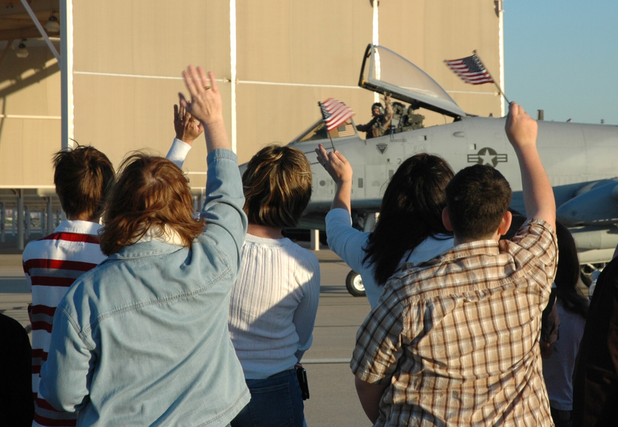 Friends and family exchange farewell waves with an A-10 pilot from the 354th Fighter Squadron here, as he makes his way to the runway for takeoff. Twelve pilots from the 354th FS left for Afghanistan April 7, as part of a larger D-M deployment in support of Operation Enduring Freedom. (U.S. Air Force photo/Airman 1st Class Melissa Taeu)