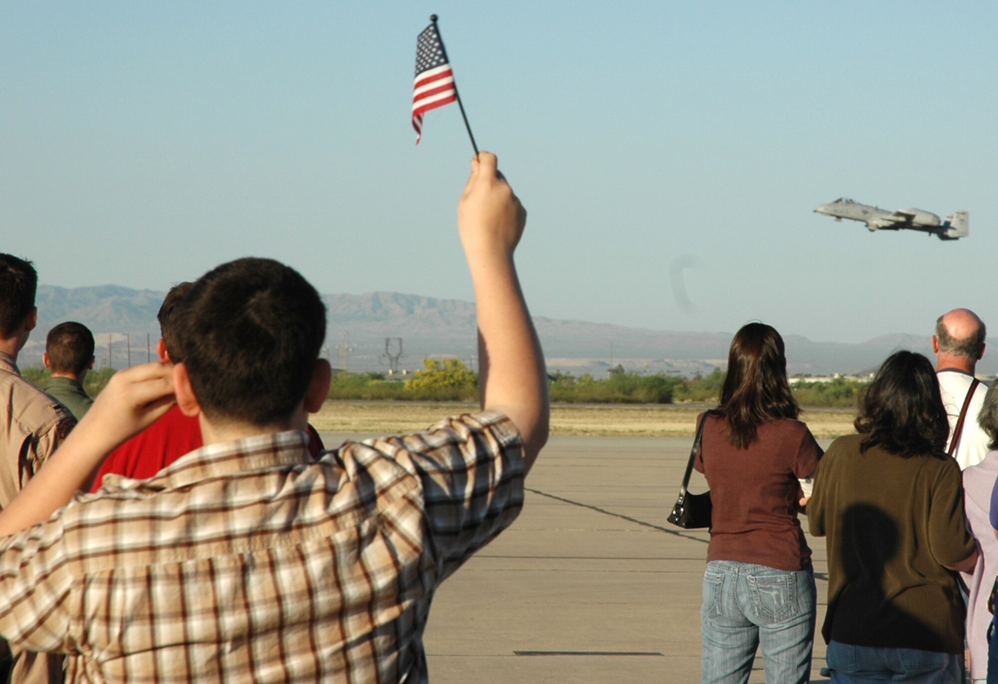 An A-10 Thunderbolt II from the 354th Fighter Squadron takes off from D-M, as friends, family members and colleagues bid farewell. Twelve pilots from the 354th FS deployed Saturday to Afghanistan to support Operation Enduring Freedom. (U.S. Air Force photo/Airman 1st Class Melissa Taeu)