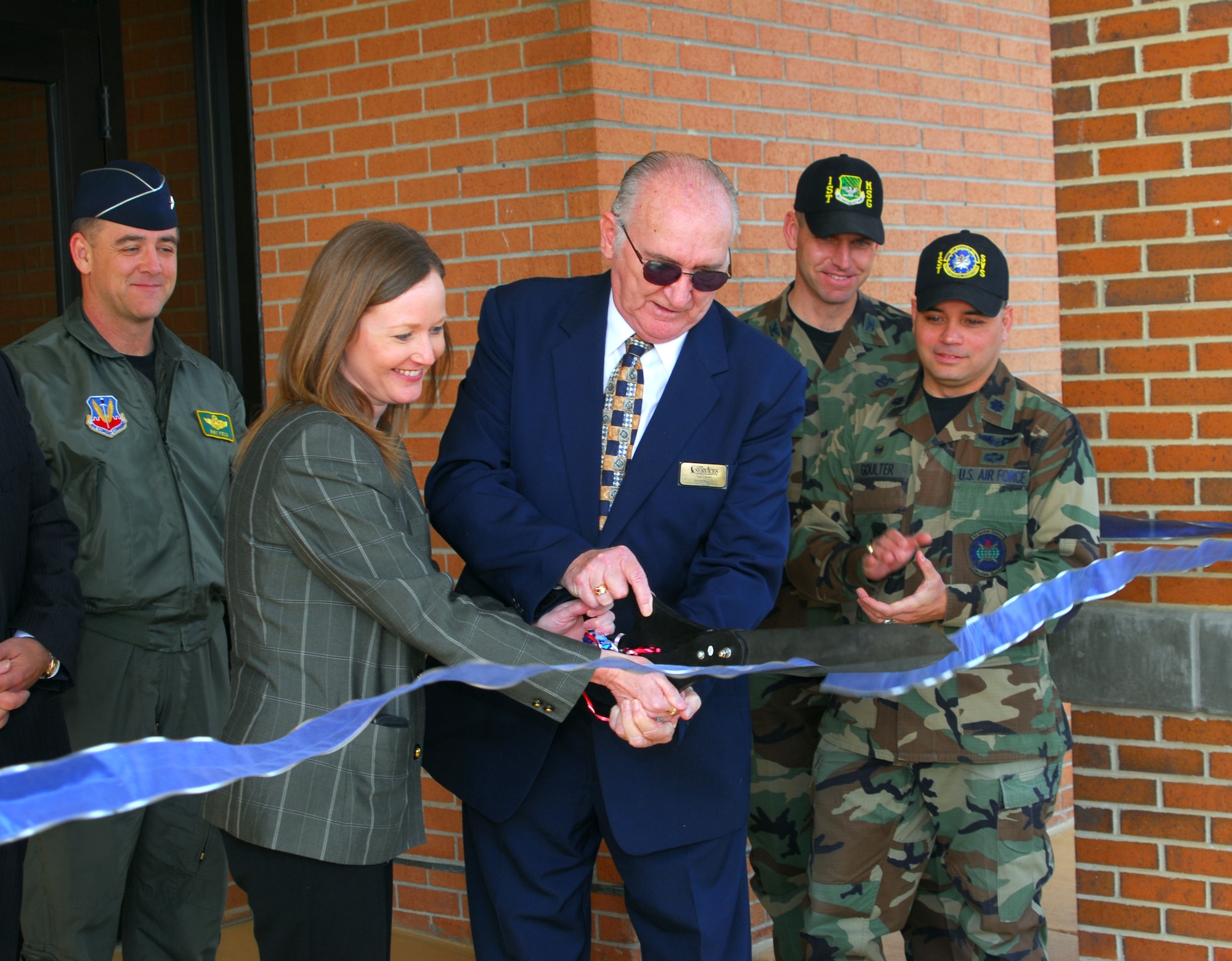 (From left) Brig. Gen. Burt Field, 1st Fighter Wing commander; Brenda Cook, deputy base civil engineer; Frank Cooney, Langley Air Force Inns manager; Col. Brian Yolitz, 1st Mission Support Group commander, and Lt. Col. Thomas Goulter, 1st Services Squadron commander, gathered for the Bayview Towers ribbon cutting ceremony April 9. The facility was renovated as a temporary living facility after Hurricane Isabel caused severe damage in 2003. (U.S. Air Force photo/Eric Deagle)