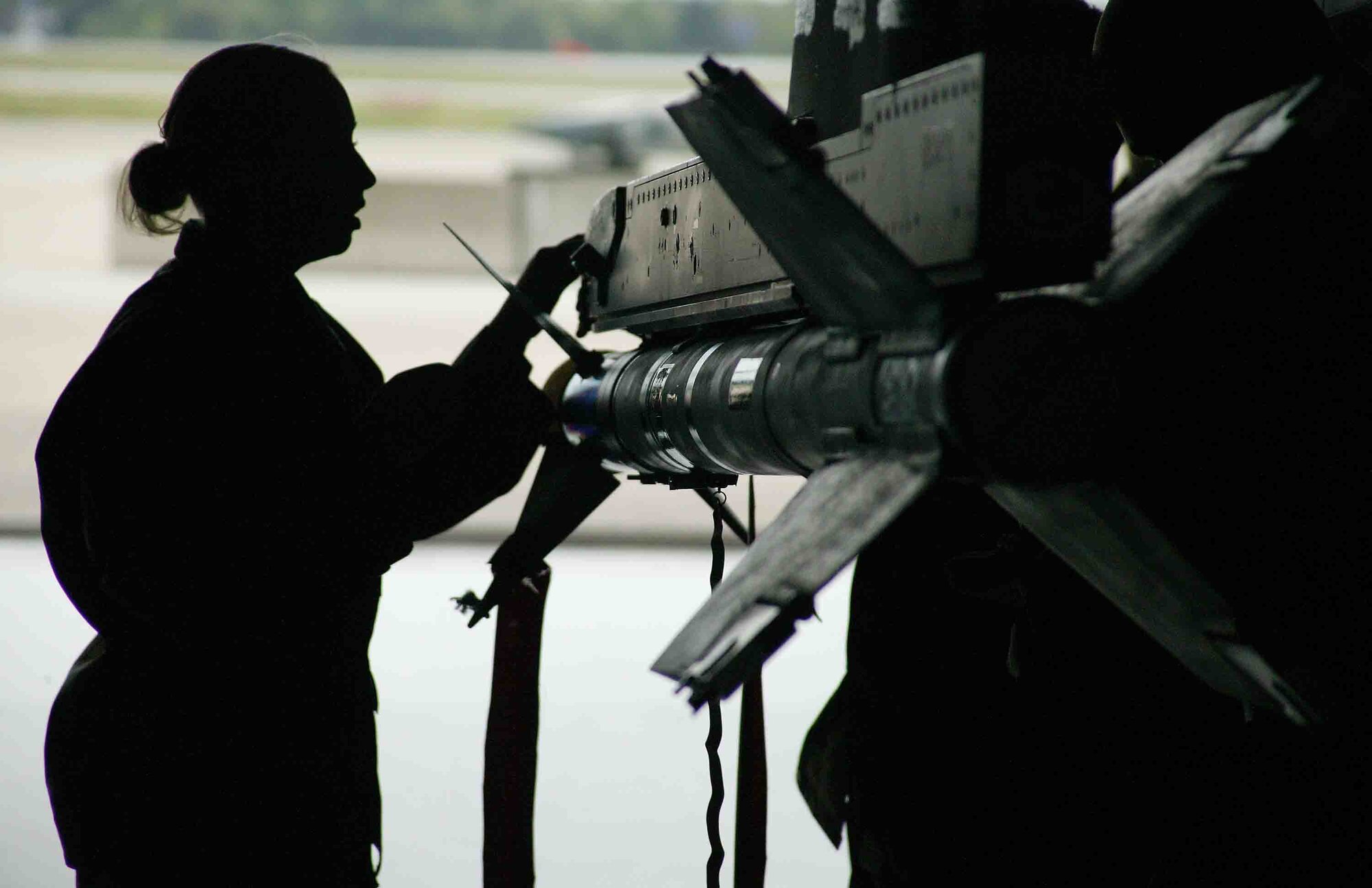 SHAW AIR FORCE BASE, S.C. -- Airman 1st Class Christina Windsor, 55th Aircraft Maintenance Unit weapons loader, closes the forward fair on the missile launcher after connecting the AIM-9 missile umbilical to the launcher receptacle during the load crew competition April 6 in Hangar 1611. Load crew competitions are designed to promote morale and increase proficiency, knowledge, professionalism and integrity. (U.S. Air Force photo/Senior Airman John Gordinier)
