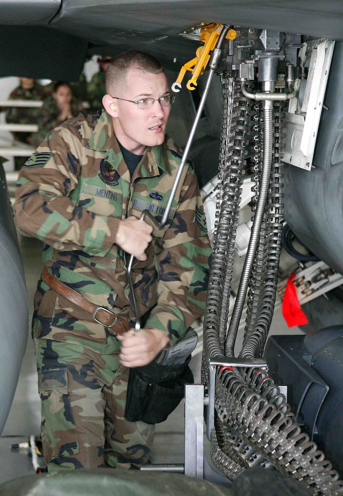 SHAW AIR FORCE BASE, S.C. -- Staff Sgt. Ryan Menting, 79th Aircraft Maintenance Unit weapons loader, cranks 20-millimeter ammunition into the internal gun system on an F-16CJ during the load crew competition April 6 in Hangar 1611. Load crew competitions are designed to promote morale and increase proficiency, knowledge, professionalism and integrity. (U.S. Air Force photo/Senior Airman John Gordinier)