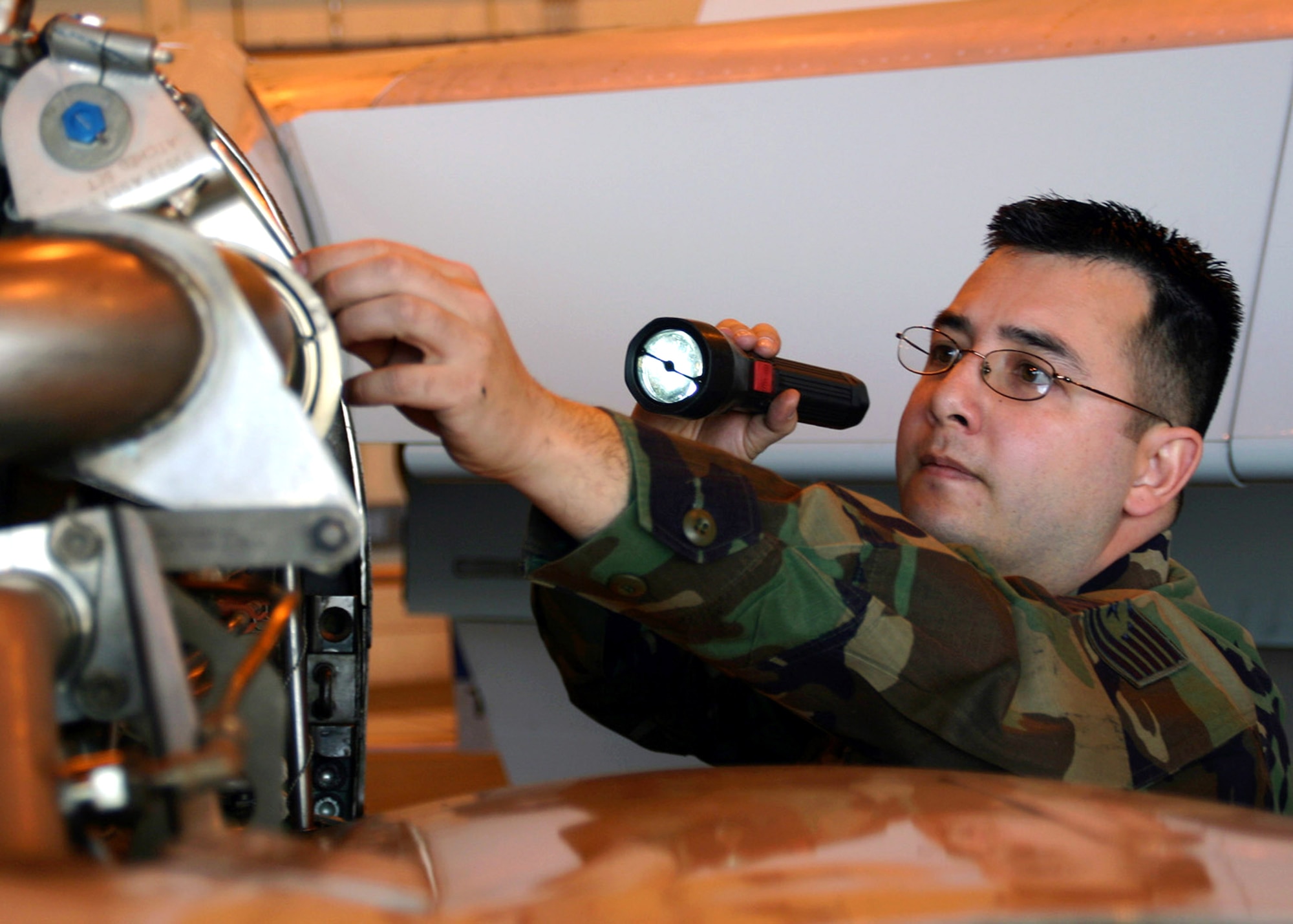 Tech. Sgt. Roy Wiggen takes a look at an E-3 Sentry as it has its annual isochronal inspection April 4 at Tinker Air Force Base, Okla. Inspections were done every 180 days, but through Air Force Smart Operations for the 21st century processes the inspections were changed to once a year, saving the Air Force time and money, and allowing theater commanders more use of the E-3. Sergeant Wiggen is assigned to the 552nd Maintenance Group Quality Assurance Division. (U.S. Air Force photo/Staff Sgt. Stacy Fowler)