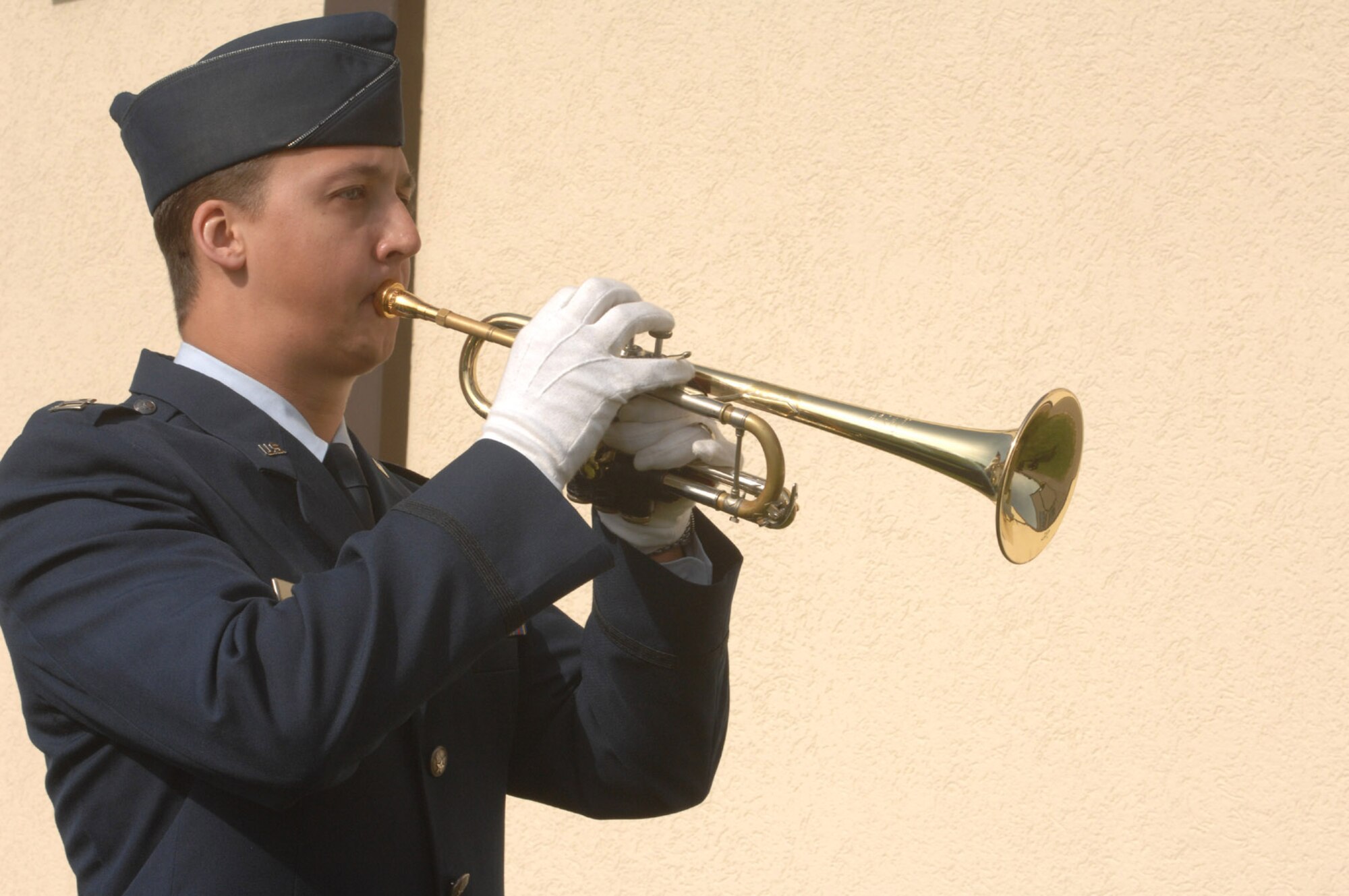 SPANGDHALEM AIR BASE, GERMANY – Capt. Mike McCarthy, 23rd Fighter Squadron, plays Taps during a ceremony memorializing the life of Maj. Troy Gilbert at Bitburg High School April 5. Major Gilbert a BHS graduate lost his life while serving in support of Operation Iraqi Freedom Nov. 26 while he was on a mission providing combat support to an Army helicopter crew that had crashed as well as the ground forces trying to reach the crash site in the Anbar Province, 20 miles northwest of Baghdad. (US Air Force photo by Airman 1st Class Emily Moore)