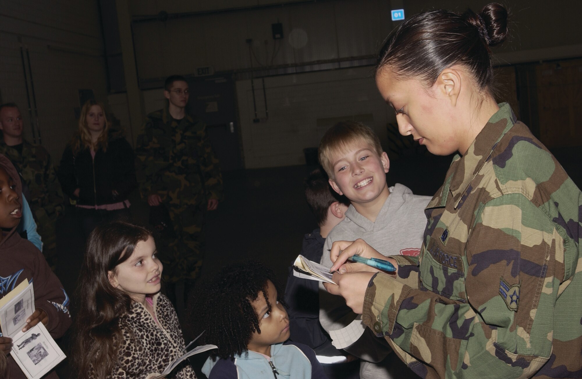 SPANGDAHLEM AIR BASE, GERMANY -- Airman 1st Class Angela Cowley, 52nd Logistics Readiness Squadron, signs off on the children’s checklists during Logistics Readiness Squadron Family Day. The days events were designed to show family members the inter-workings of the 52nd LRS.  (US Air Force photo/Staff Sgt. Ray Mills)  