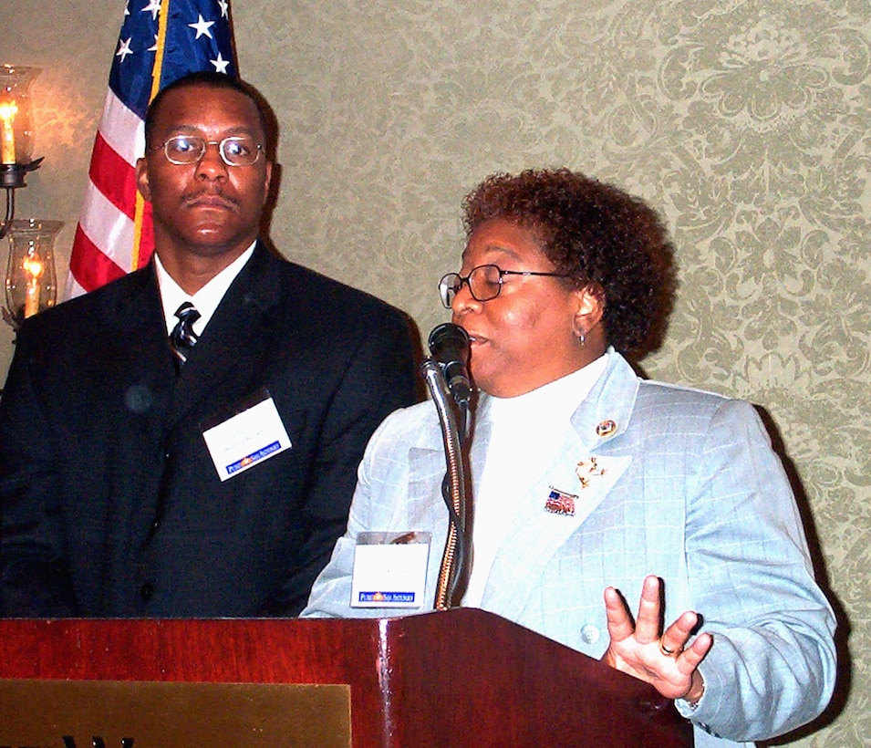 Ileen Rogers of the Military Child Education Coalition  introduces Navy Chief Petty Officer Bernard Curtis Brown at the annual  coalition conference held recently in San Antonio, Texas. Brown's son  is the namesake of the MCEC's new Bernard Curtis Brown II Memorial NASA  Space Camp Scholarship. The young Brown, 11, died aboard American  Airlines Flight 77 when the terrorists slammed the plane into the  Pentagon on Sept. 11, 2001. Photo by Rudi Williams.