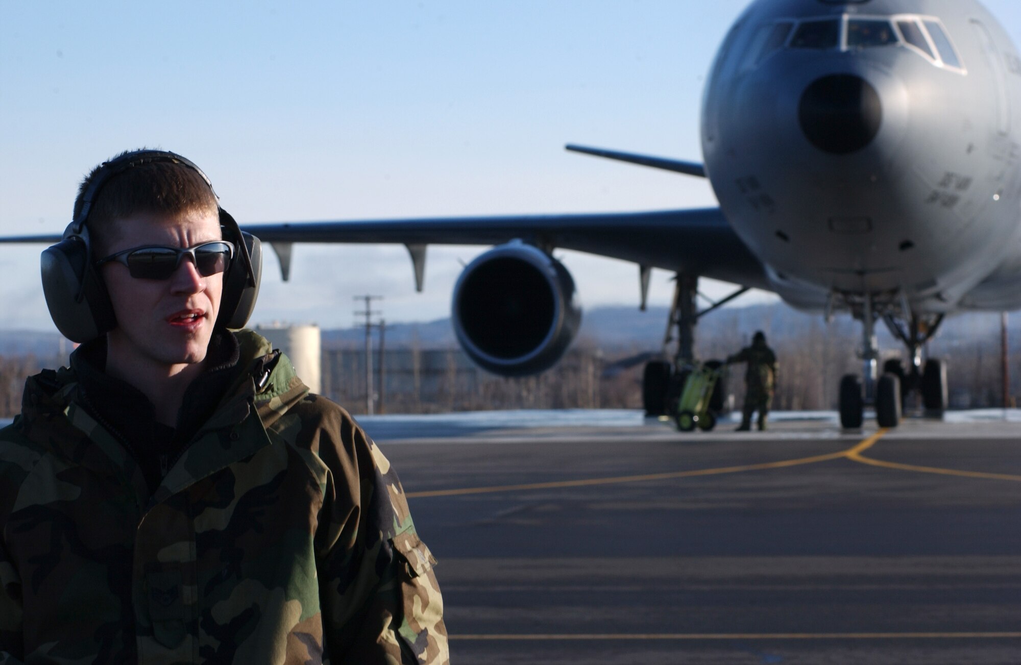 EIELSON AIR FORCE BASE, Alaska -- Staff Sgt. Martin Walker, 305th Maintenance Squadron, McGuire AFB, N.J., marshals a KC-10 Extender on April 13 during Red Flag-Alaska 07-1. This aircraft supports Red Flag-Alaska by performing aerial refueling allowing longer flight time for fighter jets conducting simulated air combat training missions over the Pacific Alaskan Range Complex. (U.S. Air Force Photo by Airman 1st Class Jonathan Snyder)