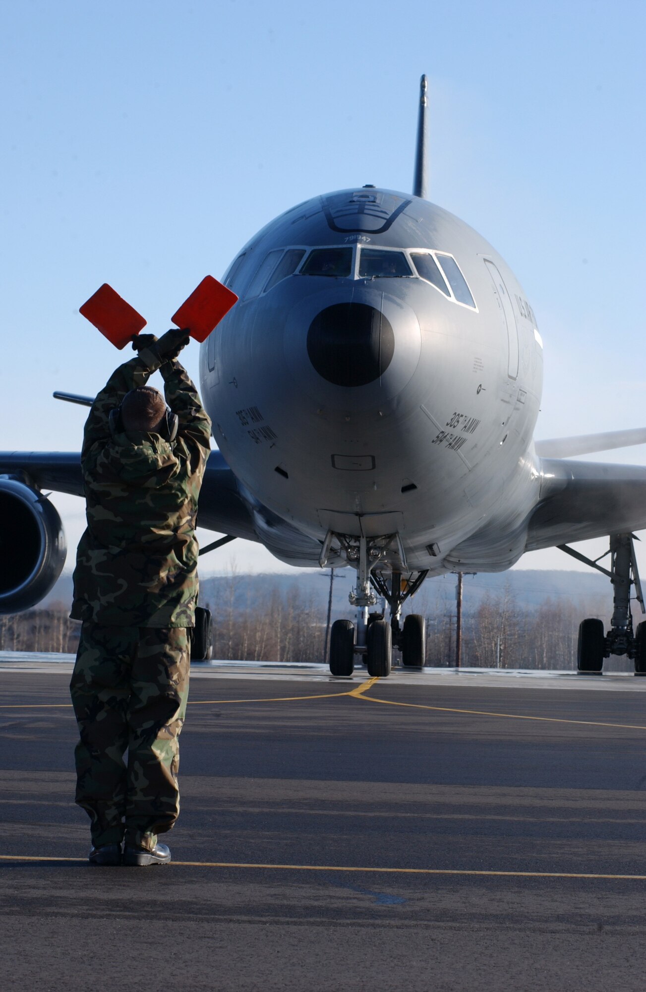 EIELSON AIR FORCE BASE, Alaska -- Staff Sgt. Martin Walker, 305th Maintenance Squadron, McGuire AFB, N.J., proceeds into place to marshal a KC-10 Extender on April 13 during Red Flag-Alaska 07-1. Red Flag-Alaska is a Pacific Air Forces-directed field training exercise for U.S. forces flown under simulated air combat conditions. It is conducted on the Pacific Alaskan Range Complex with air operations flown out of Eielson and Elmendorf Air Force Bases. (U.S. Air Force Photo by Airman 1st Class Jonathan Snyder)