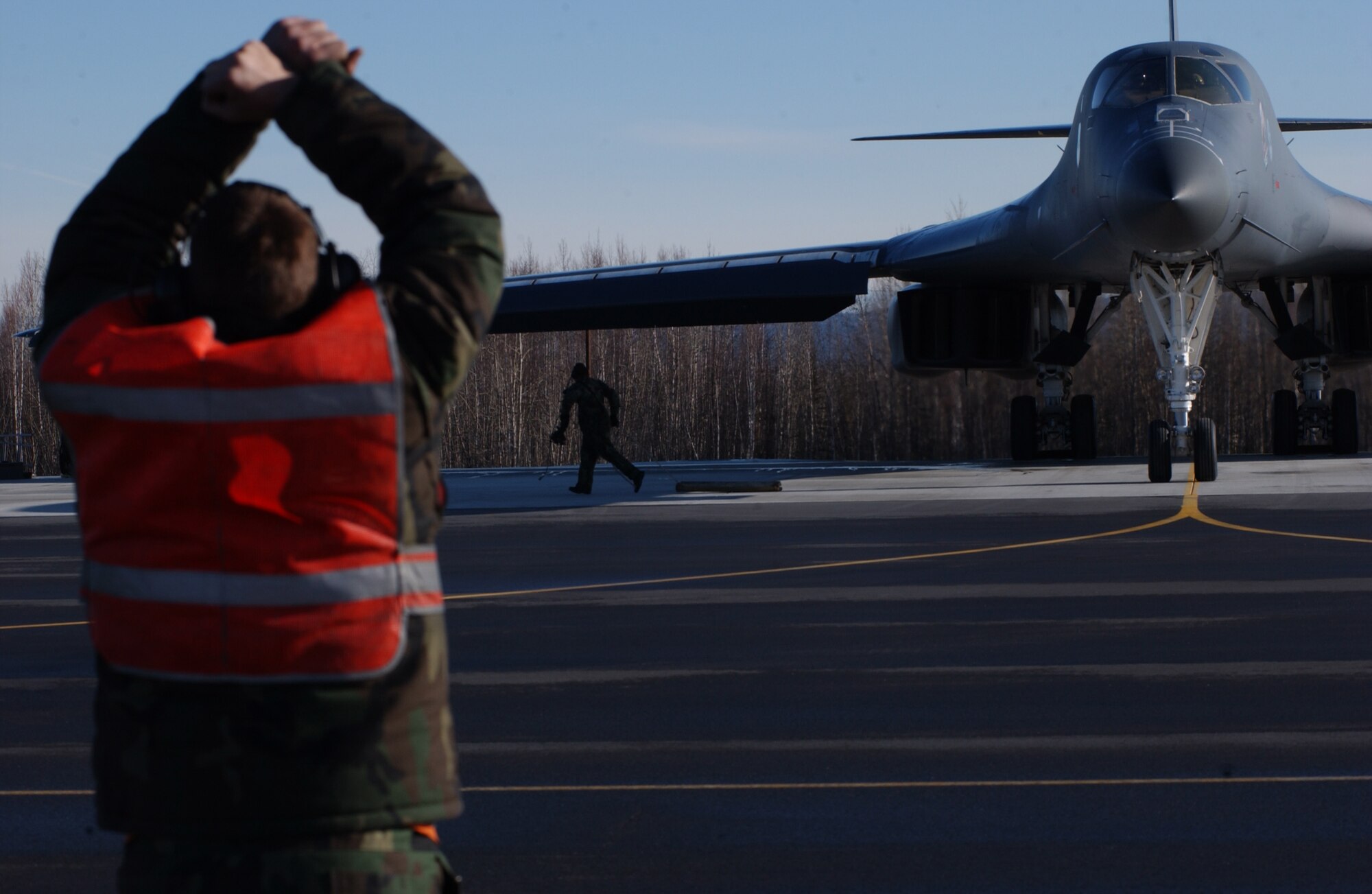 EIELSON AIR FORCE BASE, Alaska -- Senior Airman Michael Anderson, 28th Aircraft Maintenance Squadron, Ellsworth Air Force Base, S.D., marshals a B-1B Lancer on April 13 during Red Flag-Alaska 07-1. Red Flag-Alaska is a Pacific Air Forces-directed field training exercise for U.S. forces flown under simulated air combat conditions. It is conducted on the Pacific Alaskan Range Complex with air operations flown out of Eielson and Elmendorf Air Force Bases. (U.S. Air Force Photo by Airman 1st Class Jonathan Snyder)