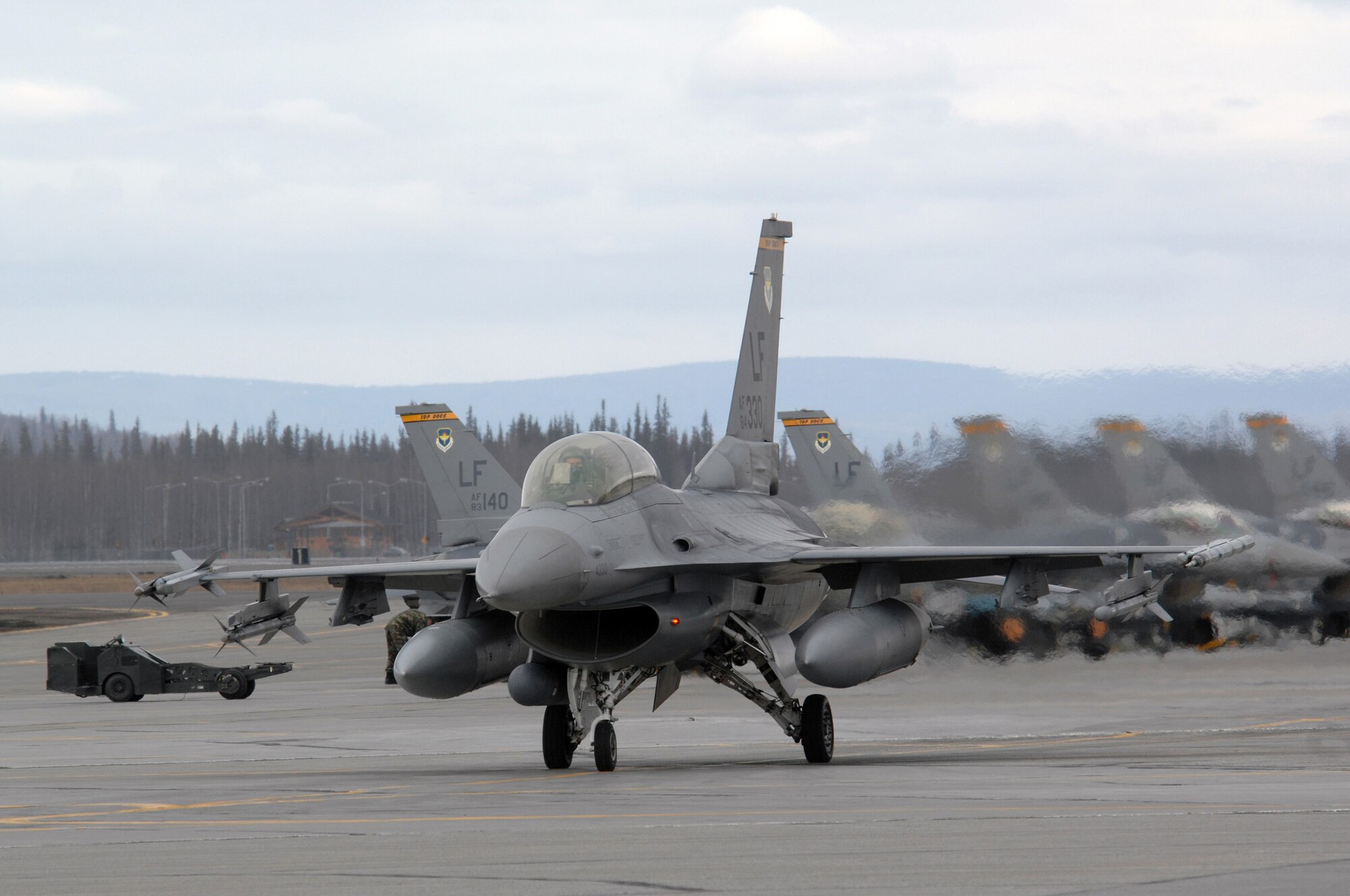 An F-16 Fighting Falcon from the 61st Fighter Squadron taxis prior to a mission during Red Flag-Alaska 07-1 at Eielson Air Force Base, Alaska, April 11. Red Flag-Alaska is a Pacific Air Forces-directed field training exercise for U.S. forces flown under simulated air combat conditions. It is conducted on the Pacific Alaskan Range Complex with air operations flown out of Eielson and Elmendorf Air Force Bases. (Photo by Staff Sgt. Joshua Strang)