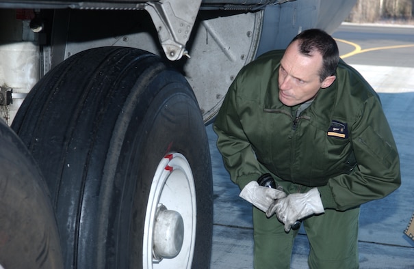 EIELSON AIR FORCE BASE, Alaska -- Senior Master Sgt. Auffret, French Air Force flight engineer, inspects the landing gear of a C-130 prior to take off on April 13 during Red Flag-Alaska 07-1. Red Flag-Alaska is a Pacific Air Forces-directed field training exercise for U.S. forces flown under simulated air combat conditions. It is conducted on the Pacific Alaskan Range Complex with air operations flown out of Eielson and Elmendorf Air Force Bases. (U.S. Air Force Photo by Airman 1st Class Jonathan Snyder)