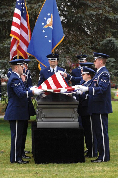 MCCHORD AIR FORCE BASE, Wash.--Members of the base honor guard give the U.S. flag the first of 10 distinctive folds recently during a practice session designed to ensure ceremonial procedures are accurate and comply with all applicable instructions. (U.S. Air Force Photo by Abner Guzman)