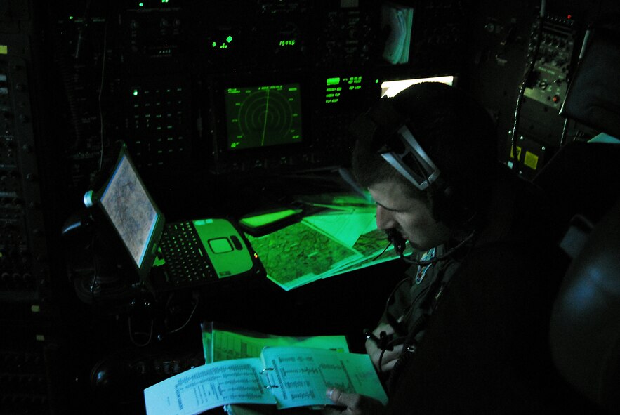 Capt. Justin Davis, 71st Rescue Squadron HC-130P navigator, relays a piece of threat information to the other members of his crew during a night training mission here April 10. Navigators perform a vital role during rescue missions, operating radar and infrared sensors along with precise mapping software to find a safe route through mountains while avoiding enemy threats.   (U.S. Air Force photo by Tech. Sgt. Parker Gyokeres)