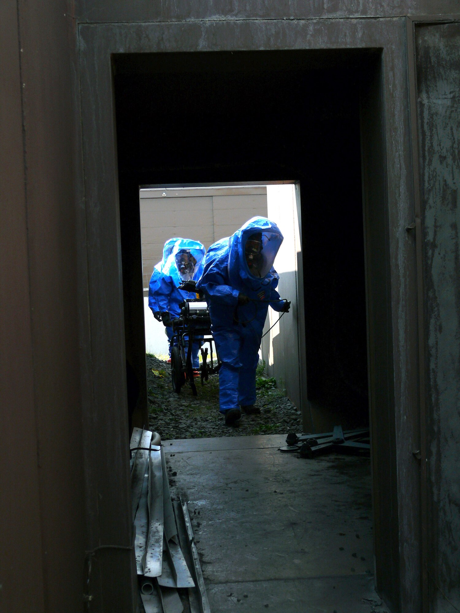 During training, Airmen and Soldiers enter a bunker housing a simulated chemical weapons lab April 12 at Ramstein Air Base, Germany. Responders from the Army and Air Force are training together at a chemical response exercise so they can respond as a single unit if needed. (U.S. Air Force photo) 