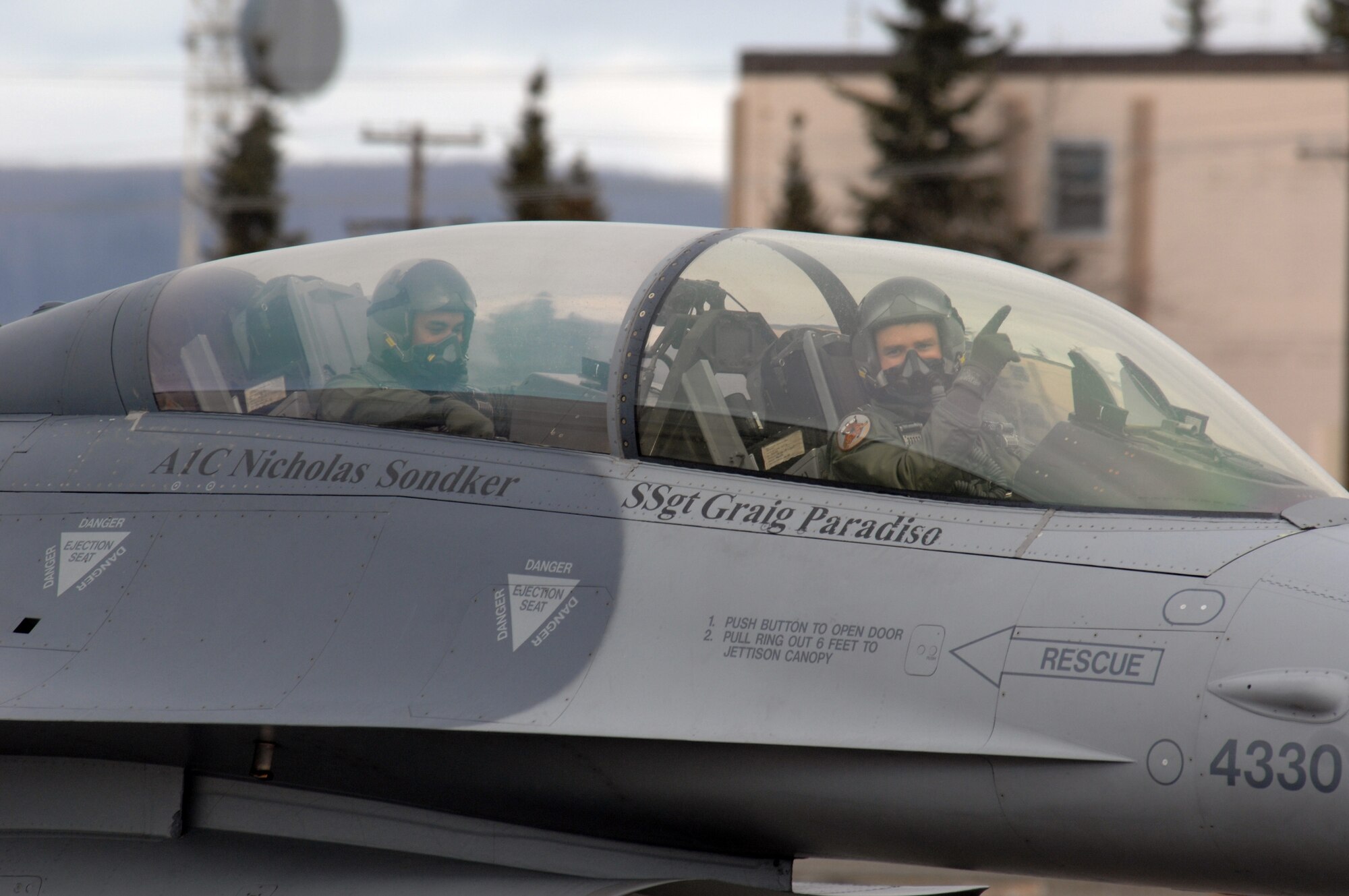 EIELSON AIR FORCE BASE, Alaska -- An F-16 Fighting Falcon pilot from the 61st Fighter Squadron, Luke Air Force Base, Arizona signals to the camera prior to a mission during Red Flag-Alaska 07-1. Red Flag-Alaska is a Pacific Air Forces-directed field training exercise for U.S. forces flown under simulated air combat conditions. It is conducted on the Pacific Alaskan Range Complex with air operations flown out of Eielson and Elmendorf Air Force Bases. 
(U.S. Air Force Photo by Staff Sgt Joshua Strang) 