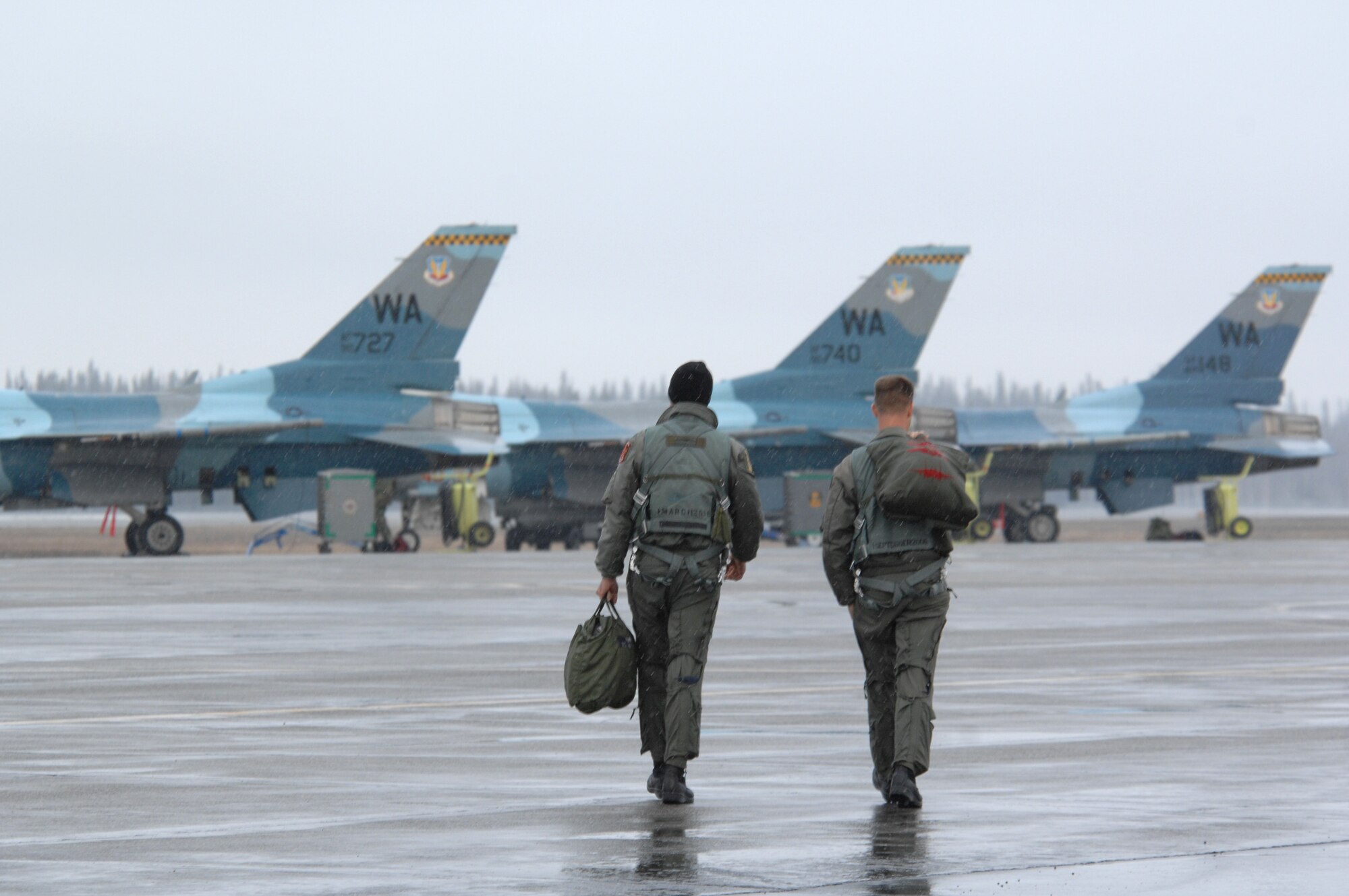 EIELSON AIR FORCE BASE, Alaska -- Two F-16 Fighting Falcon pilots from the 64th Aggressor Squadron, Nellis Air Force Base, Nevada step to their jets prior to a mission during Red Flag-Alaska 07-1. Red Flag-Alaska is a Pacific Air Forces-directed field training exercise for U.S. forces flown under simulated air combat conditions. It is conducted on the Pacific Alaskan Range Complex with air operations flown out of Eielson and Elmendorf Air Force Bases. 
(U.S. Air Force Photo by Staff Sgt Joshua Strang) 