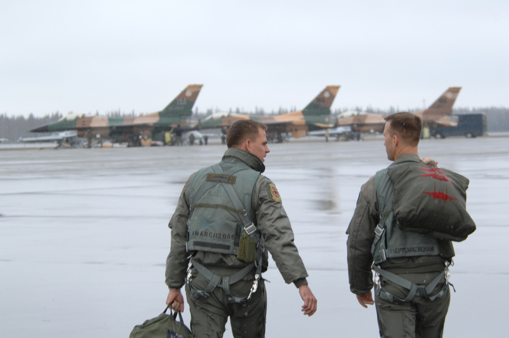 EIELSON AIR FORCE BASE, Alaska -- Two F-16 Fighting Falcon pilots from the 64th Aggressor Squadron, Nellis Air Force Base, Nevada step to their jets prior to a mission during Red Flag-Alaska 07-1. Red Flag-Alaska is a Pacific Air Forces-directed field training exercise for U.S. forces flown under simulated air combat conditions. It is conducted on the Pacific Alaskan Range Complex with air operations flown out of Eielson and Elmendorf Air Force Bases. 
(U.S. Air Force Photo by Staff Sgt Joshua Strang) 