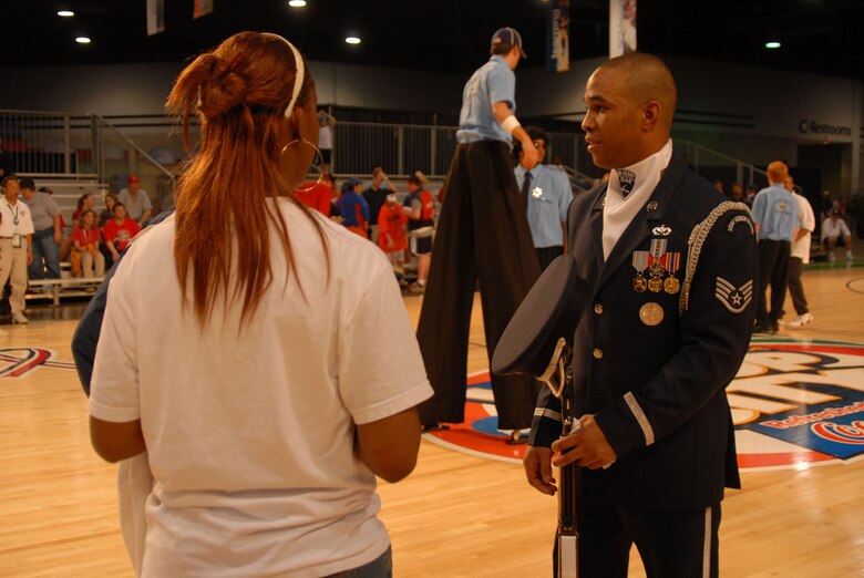 ATLANTA -- Staff Sgt. Levi Duncan, Air Force Honor Guard Drill Team operations NCOIC, talks with fans after the team's performance at the NCAA Final Four Hoop City events April 1.  The Drill Team was in Atlanta throughout the weekend performing at various events associated with the NCAA Final Four Tournament, including the opening ceremonies at Centennial Olympic Park March 30.