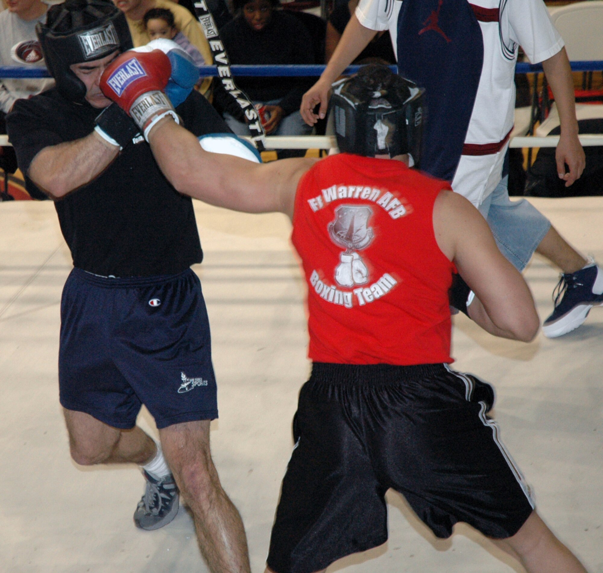 First Lt. Dave "Fauxhawk" Suszko, 319th Missile Squadron, lands a left hook on Tech. Sgt. Gordon Lewis, 90th Missile Security Forces Squadron, during a boxing exhibition in Fall Hall Saturday (Photos by Airman Alex Martinez).