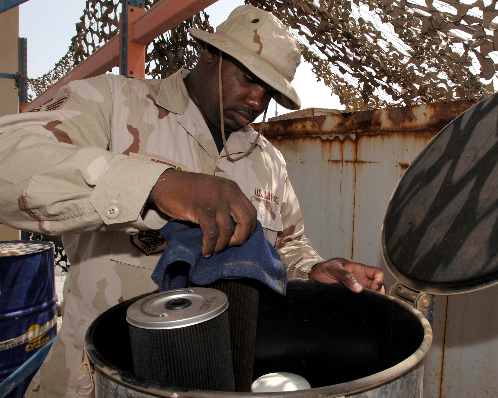 Staff Sgt. Harvey Peters prepares a 55-gallon drum of used engine oil April 12 for inspection at the hazardous waste collection point at Camp Patriot an undisclosed location in Southwest Asia. The collection point is the sole waste collection site for the Air Force, Army, Navy and Marines. Sergeant Peters is assigned to the 586th Expeditionary Mission Support Group's Civil Engineer Flight. (U.S. Air Force photo/Tech. Sgt. Edward D. Holzapfel)