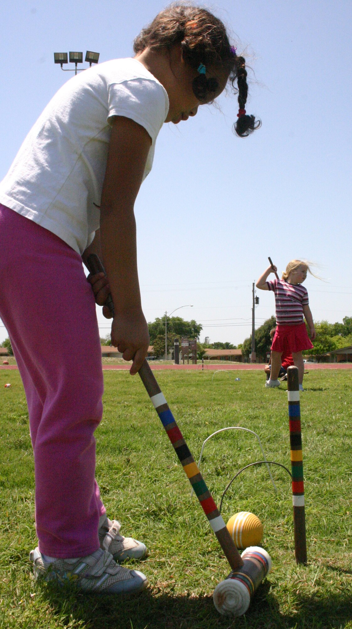 LAUGHLIN AIR FORCE BASE, Texas -- Olivia Winters, daughter of Melissa and Jim Winters,Lear Siegler Incorporated, along with fellow classmates of Texas Hope, a home school group, learn how to play a simple version of croquet during their physical education class on the base football field April 12, 2007. (U.S. Air Force photo by Airman Sara Csurilla)