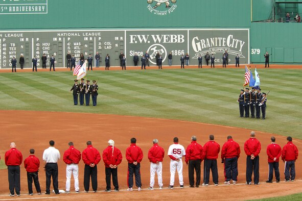 Hanscom’s Patriot Honor Guard, joined by flag details from other services, present the colors at the Boston Red Sox Opening Day ceremony at Fenway Park April 10. Various volunteers from Hanscom also lined the field that afternoon during the pre-game festivities. The Red Sox entered the bottom of the fifth inning with an 11-1 lead against the Seattle Mariners, winning the game with an overall score of 14-3. (U.S. Air Force Photo by Walter Santos)