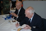 Retired Lt. Col. Richard "Dick" Cole, left, and retired Col. C.V. Glines, an honorary Doolittle Raider, appear at a book-signing event at the Randolph AFB Base Exchange March 30. (USAF photo by Raymond V. Whelan)