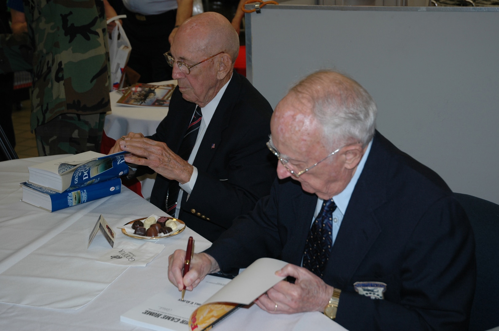 Retired Lt. Col. Richard "Dick" Cole, left, and retired Col. C.V. Glines, an honorary Doolittle Raider, appear at a book-signing event at the Randolph AFB Base Exchange March 30. (USAF photo by Raymond V. Whelan)