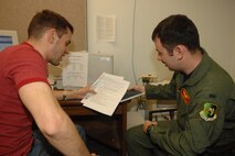 MINOT AIR FORCE BASE, N.D. – First Lt. Dominic Amaturo, (left) 741st Missile Squadron, assists 1st Lt. Charles Shank, 23rd Bomb Squadron, file his taxes at the base tax center here April 13. April 17 is the deadline to file taxes. All active-duty service members, retirees, and reservists on active duty for 30 days or more, as well as family members, are eligible for free tax assistance at the base tax center. For tax-related information or to make an appointment, call 723-7377. (U.S. Air Force photo by SrA Christopher Boitz)