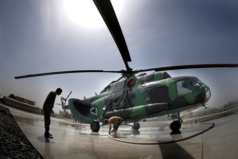 Afghan National Air Corp maintainers wash down an MI-17 helicopter April 9 on the Kabul International Airport flightline. Air Force mentors assigned to Defense Reform Directorate Air Division under Combined Security Transition Command - Afghanistan provide guidance to soldiers with the Maintenance Operations Group for the ANAC. (U.S. Air Force photo/Tech. Sgt. Cecilio M. Ricardo Jr.)