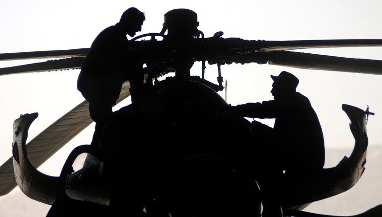 Afghan National Air Corp maintainers repair MI-35 helicopter April 9 on the Kabul International Airport flightline. Air Force mentors assigned to Defense Reform Directorate Air Division under Combined Security Transition Command - Afghanistan provide guidance to soldiers with the Maintenance Operations Group for the ANAC. (U.S. Air Force photo/Tech. Sgt. Cecilio M. Ricardo Jr.)
