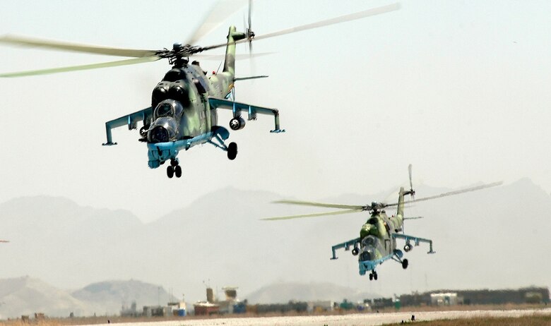 Afghan National Air Corps MI-35 helicopters take off in a formation practice for the aerial parade in the upcoming Afghan National Day in Kabul. Air Force mentors assigned to Defense Reform Directorate Air Division under Combined Security Transition Command - Afghanistan provide guidance to soldiers with the Maintenance Operations Group for the ANAC. (U.S. Air Force photo/Tech. Sgt. Cecilio M. Ricardo Jr.)