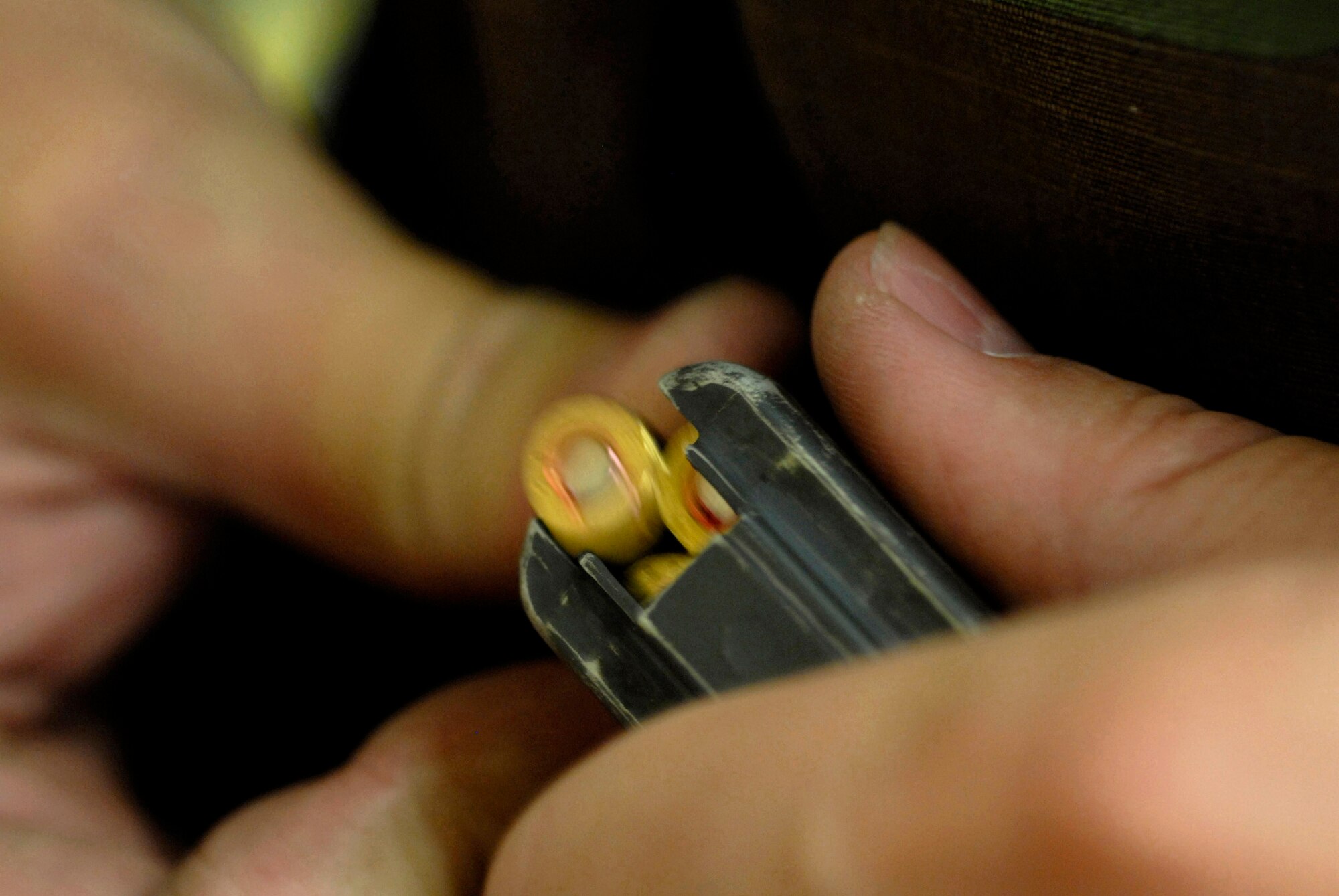 An Airman loads a magazine with 5.56mm ammunition, preparing for the next series of firing April 12 at Luke Air Force Base, Ariz. Airmen must be qualified in their primary weapon prior to deploying in support of the war on terrorism. There are more than 28,000 Airmen deployed around the world today. (U.S. Air Force photo/Senior Airman Christopher Hummel)
