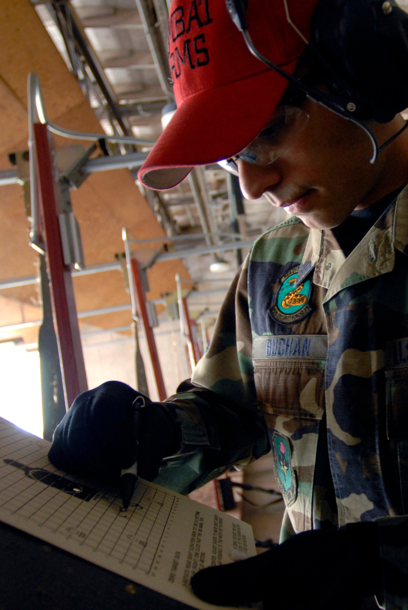 Staff Sgt. Matthew Buchan designates missed shots during a tactical rifle qualification course April 12 at Luke Air Force Base, Ariz. Sergeant Buchan is a combat arms instructor for the 56th Security Forces Squadron. Airmen must be qualified in their primary weapon prior to deploying in support of the war on terrorism. There are more than 28,000 Airmen deployed around the world today. (U.S. Air Force photo/Senior Airman Christopher Hummel)
